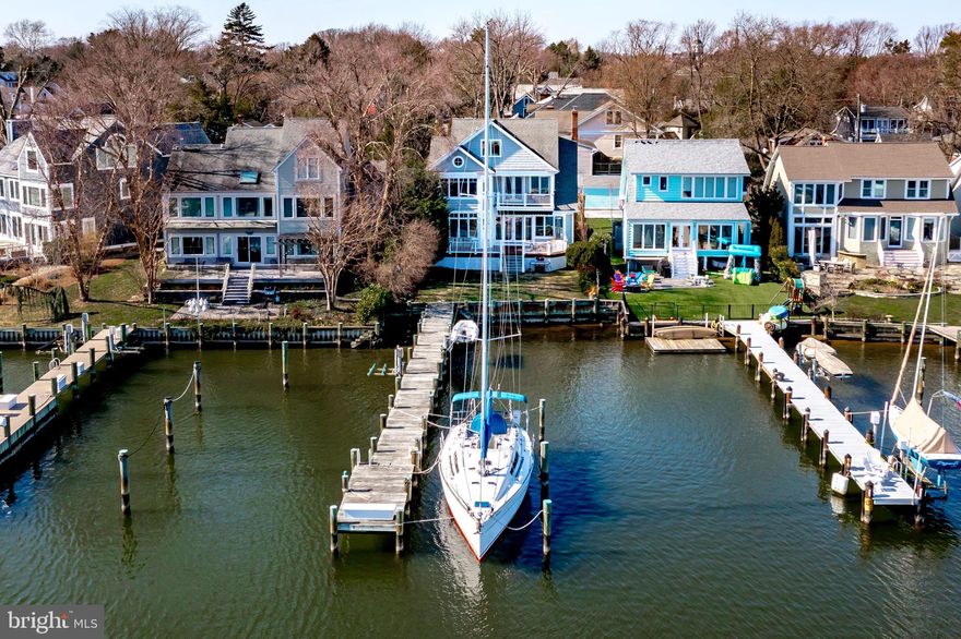 Deep water pier and walk to town location, a rare find!!  This Coastal home was designed by award-winning architect Scott Rand on a prime waterfront Eastport lot with impressive views of Back Creek and the Chesapeake Bay. A 2003 renovation and addition makes the most of a southern exposure, four BR’s, two full and three half-baths, pine floors and three levels of living space.  An open first-floor plan boasts an upgraded kitchen, dining room, living room with wood-burning fireplace, a private office, and a spacious family room that opens to a large Ipe waterfront deck with views of Back Creek.  Waterfront primary bedroom suite opens to an upper deck with long water views.  The top loft floor with magnificent views offers a large open space for flexible use, a half bath, a perfect get-a-way for an office or overnights for an extended family.  A deep-water private dock to accommodate a large yacht and other water craft.  Located less than a mile from downtown Annapolis and the Naval Academy.  You can enjoy numerous Eastport restaurants, take an easy walk across the Spa Creek bridge, or catch the water taxi from your private dock to downtown Annapolis. Welcome home!