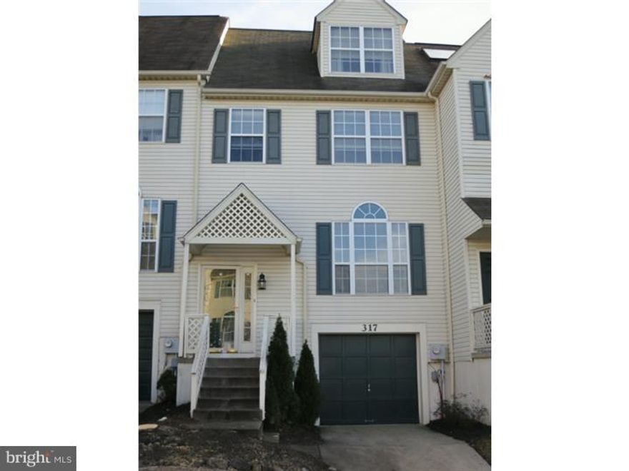 This spacious 4-bedroom, 2.5-bath Cinnamon Hill townhome community offers a perfect blend of comfort, convenience and super location being on a cul de sac location. The home features a 1-car garage with additional driveway parking and solid oak hardwood floors throughout the first floor. Upon entry, you're welcomed into a 2 story entry foyer with a large coat closet and a powder room for guests. The expansive living room is filled with natural light from large windows and flows into the dining area. The breakfast room and full kitchen are perfect for everyday living, showcasing wood cabinetry, corian countertops, stainless steel refrigerator and dishwasher, a ceramic tile backsplash, an outside cooking vent, and a sliding door that leads to the oversized wood deck—ideal for outdoor entertaining. The master bedroom boasts vaulted ceilings, a walk-in closet, and an additional closet, along with a full ceramic-tiled bathroom complete with a tub/shower. Two additional bedrooms on the second floor feature charming chair rails and ample closet space, while a linen closet and a ceramic-tiled hall bath with a tub/shower complete the upper level. The third-floor bedroom is a private retreat, featuring a skylight, generous space, and a walk-in closet.  The unfinished basement offers great potential, with plenty of space that could easily be finished to suit your needs. It also includes a laundry area with a utility tub, along with additional storage​.  The 1-car garage also provides additional storage options. This home is equipped with a 200-amp electrical service, custom wood blinds, Central Air and is ideally located close to SEPTA's Ivy Ridge Train Station, parks biking and walking trails and the vibrant shops and restaurants of Manayunk.