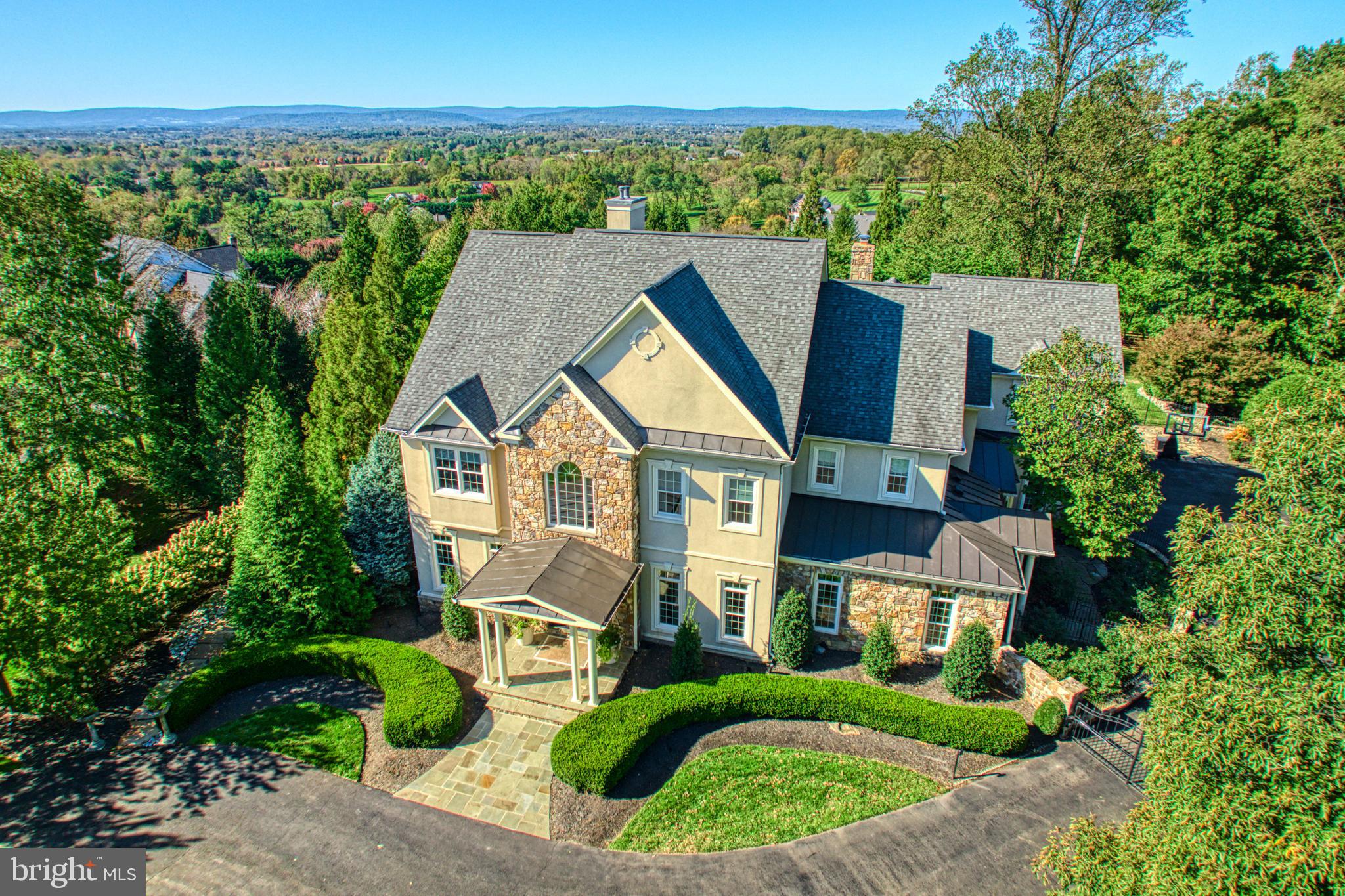 Welcome to 40428 Spectacular Bid Pl, a stunningly renovated 3 acre estate in Leesburg, VA, offering luxurious living with breathtaking open views of the Blue Ridge. This exquisite residence boasts 6 bedrooms, 7 full bathrooms and 2 half baths, showcasing sophisticated architectural elements, and a gorgeous top of the line remodeled kitchen by BOWA.

Step inside to find a grand foyer leading to an array of beautifully appointed rooms, including a formal dining room with custom wine wall, family room with built in media, gas fireplace, and dry bar. Gourmet kitchen with chandeliers, 2 islands, Sub Zero refrigerator, Miele appliances including gas stove, steam oven, warming drawers, 2 dishwashers, coffee bar with two wine refrigerators, glass doors leading to a butlers enclave/prep kitchen with additional island, built in cabinets, laundry, and storage. Additional rooms include home office, sunroom, library/den, exercise room, media room, second kitchen on lower level with bar and ice maker, laundry on all three levels, custom lighting throughout, Sonos speakers, and all new doors.

Berdrooms include a main level suite with full bath and french doors to balcony. The upper level boasts a large primary suite with exquisite full bath including heated floors, oversized glass shower, freestanding tub, 2 vanity areas, and 2 custom designed walk in closets. There are 3 more additional bedrooms with full baths on the upper level. The lower level has a private living suite with separate entrance, full bath, walk in closet, and laundry. 

The outdoor living is equally impressive with multiple private stone patios and balconies, outdoor kitchen with Wolf bbq, beverage refrigerators, fireplace, heated private pool with electric cover, spa, fire pit, custom play set, and beautifully landscaped grounds. The property also includes 3 car attached garage, guest parking ensuring ample space for all your needs, custom outdoor lighting, and new invisible fence. Security gate and security system with cameras installed.

This home is the epitome of luxury and comfort, ready to welcome its new owners. Don't miss the opportunity to make 40428 Spectacular Bid Pl your new address. Schedule a showing today!