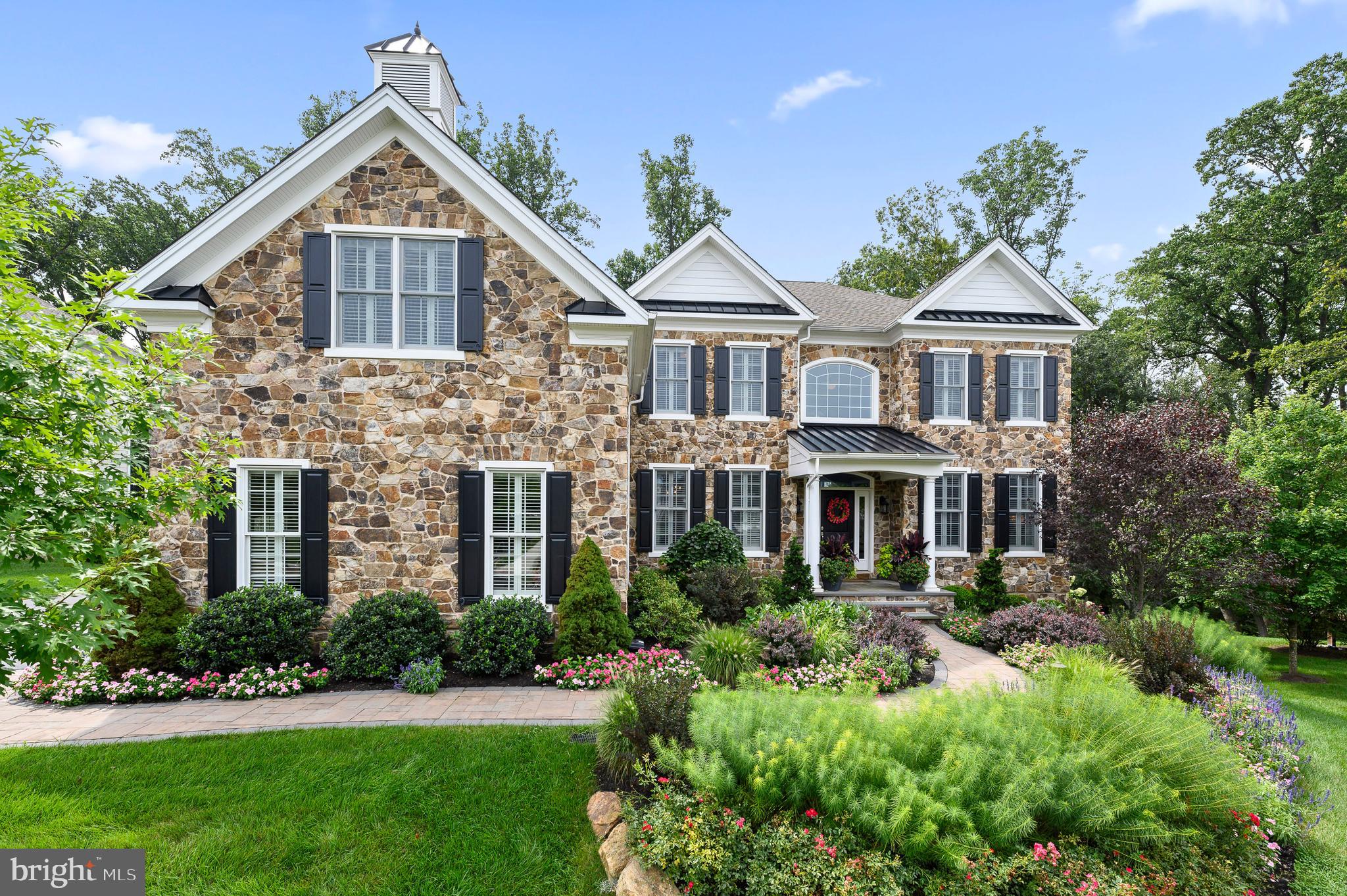 Welcome to 3910 Lewis Run Road in the highly sought after sprawling community of Liseter. This stunning custom built Duke Model offers 4 bedrooms, 3 full baths and one half bath and sits on a beautiful, uniquely private lot which backs up to a lush preserve.
The exquisite all stone front elevation is enhanced with upgraded exterior lighting, professionally manicured plantings and landscaping, paver sidewalk and welcoming flagstone porch.
Upon entering the home, you are welcomed by a sun-lit two story foyer, curved impressive staircase, elegant dining room with custom ceiling and lighting and well appointed Living Room. The home boasts extensive millwork and hardwood floors throughout the first floor.
The open floor plan offers an extra large Family Room enhanced with a custom fireplace and mantle, and stunning Pennsylvania Reclaimed Wood Beams. The office is conveniently located adjacent to the family room with a sliding barn door entry, handsome built-in shelving and window seat, professional wallpapered accent wall, complete with custom plantation shutters. The plantation shutters are also thoughtfully installed throughout the home’s first and second floors. The office closet was designed by California Closets and provides ample organized space. The updated first floor half bath was remodeled with wainscoting, custom paint and Restoration Hardware Vanity and fixtures.
You will be wowed by the elegant, welcoming Chef’s kitchen and breakfast room. The true heart of the home offers amazing views of the private backyard, large kitchen window and beautiful custom ceiling with pendant lighting. The upgraded kitchen package includes a Wolf Gas Range, extra large island complete with beverage refrigerator, upgraded glass and wood cabinets and a walk-in pantry designed by California Closets. The conveniently located mudroom/entry is next to the laundry room and the well equipped, oversized 3 car garage. The garage comes complete with a custom California Closet shelving unit with built in wine refrigerator and an Electric Vehicle outlet.
Upstairs you will find 4 bedrooms and 3 full baths. The spacious Primary bedroom offers a relaxing sitting area, upgraded Hardwood flooring throughout, elegant marble top vanity and two extra large professionally designed closets. The Primary bath boasts a high end white clawfoot soaking tub, floor to ceiling tile in the extra large shower with glass doors and beautiful white dual vanities and custom lighting.
Also on the second floor you will find one en-suite bedroom with two more generous size bedrooms and a hall bath.
The exterior back of the home is a true private oasis complete with levels of custom deck space and a hardscaped lower level. The oversized deck is privately situated off the kitchen with a beautiful Pergola and easy to maintain Trex flooring. The lower level boasts a fabulous hardscaped seating area and built-in custom gas fireplace. The perfect place to relax or entertain. The interior lower level is a full walk out large space ready for build out if desired. This home also has an outdoor irrigation system and invisible fence installed.
It is conveniently located near Award-winning schools and renowned Golf and Country Clubs. The community offers walking trails, infinity-edge pool, beautiful clubhouse, full sized gym, sports courts and more. It is minutes from downtown Wayne, close to a new Whole Foods, ample dining choices, shopping and a short drive to the airport and major highways. Don't miss this beautiful oasis, it won't last long!