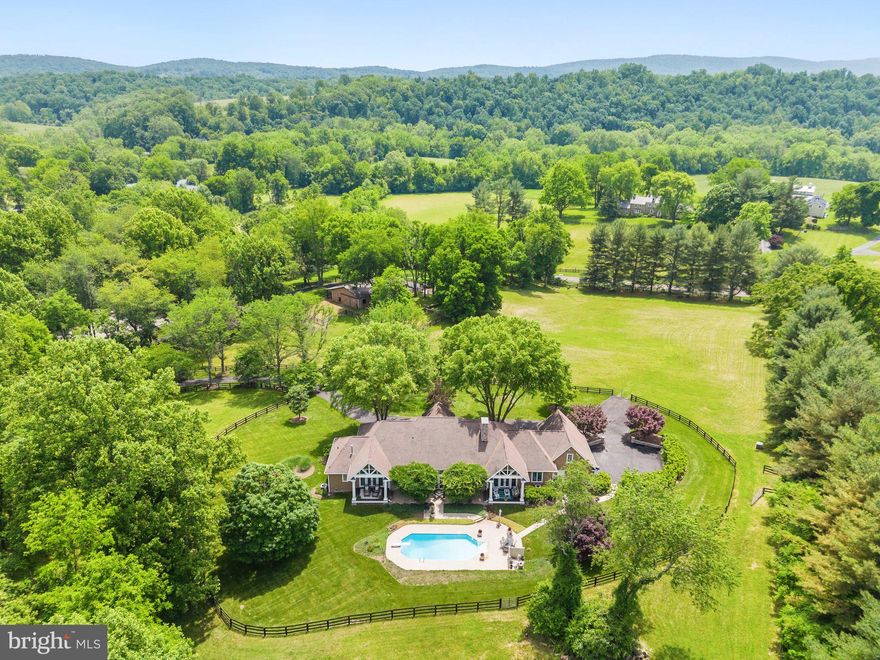 Stunning Middleburg Estate at an Unbeatable Price! Listed $300,000 below the recent appraised value.  16 acres, 7 total bedrooms, 6 bathrooms, 14' ceilings, pool, barn, riding ring, first floor Master Bedroom, gorgeous two-sided woodburning fireplace, high-speed internet, a secondary dwelling with 2 apartments, and a stream runs through it.  This one won't last long.  Reach out to the listing agent to schedule a showing.

The Welcome: As you approach the property, two stately stone pillars welcome you to Woodland Farm. A winding paved drive will guide you over the clear spring-fed stream and up the hill to the extraordinary, custom stone and Hardiplank main residence. Situated on a knoll, views of lush pastures, rolling hills, and wooded land can be seen from all sides of this exquisite home. 


The Main Residence: When you first step into the home, you will feel a sense of country elegance and peace in the foyer. To the left is a Library/Billiards Room with a gas fireplace and glass doors for quieter conversations. Designed for entertaining, this large, open Great Room with 14' ceilings with large French doors opening up to the sweeping pool and patio views will comfortably host 50 or more guests. Off the great room is a theater for those who want to watch the "big game" in style, experience a blockbuster movie in epic surround sound, or a haven for kids on the home's main level. Between the great room and the dining room is a gorgeous floor-to-ceiling double-sided stone woodburning fireplace that will create the perfect ambiance on those chilly days. The dining room has seating for 10, and the expanded island seats 4, for a total seating of 14 guests. The gourmet Kitchen has everything you need to cook a delicious meal for every day or host large family gatherings. The five bedrooms create both east and west wings, which provide perfect privacy and personal spaces. The east wing has the Master Suite and two other bedrooms, and the west wing has two larger bedrooms.  


The Internet: This property is unique because it has high-speed internet for all your home, business, and family needs. 


The Grounds: Beautifully landscaped gardens, rolling hills, a spring-fed stream, and wooded knolls provide the perfect backdrop. Imagine the romantic horse ride in the open fields, through the woods, and along the stream. The pool will add to the outdoor fun on hot summer nights. The horse enthusiast will love the five-stall center aisle horse barn, the fenced riding arena, and four separate paddocks. 


The Guest Cottages: The  two cottages have separate entrances and parking that overlook the woods and stream. They could be rented for extra income or used as housing for multigenerational living. Each Cottage can sleep up to 4 people.


The Location: This estate presents a unique opportunity to acquire a prime location in Loudoun County, with stunning natural scenery. The site's idyllic countryside setting is sure to captivate discerning buyers in search of a serene and picturesque retreat. With a strategic location just minutes away from Middleburg's charming village center, this property is ideally situated for those seeking a balance of tranquility and convenience. Don't miss out on the chance to own this exceptional piece of Loudoun County's landscape.