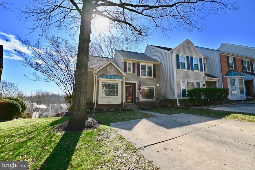 Exceptional end unit townhome boasting a main level primary bedroom, complete with an attached bathroom suite and a spacious walk-in closet. Ideal for extended families or those looking for aging-in-place convenience. The main level also features a home office and a half bath.  Main floor has gorgeous sparkling hardwoods floors that were just refinished, complemented by light-filled Palladian windows with remote-controlled motorized shades.  Patio doors on both the main and lower levels come with enclosed blinds between glass panes, providing a seamless blend of style and functionality.  Two-story living room with ceiling fan and soaring loft ceilings, adds light and architectural beauty. The updated kitchen boasts professionally painted cabinets, granite countertops, a double lazy Susan, pull-out drawers, new hardware, and stainless steel appliances.  A pass-through from the kitchen leads to a formal dining room.
Off the living room, a well-maintained, large deck overlooks a treed area, offering a touch of privacy. Hardwood stairs lead up and down to both levels. The top floor welcomes you with two additional bedrooms, a full bathroom in the hallway, and a spacious linen closet. The basement is a delightful space with tile flooring, built-in bookshelves, a gas fireplace (pilot is lit -please do not touch), and recessed lights. Another legal bedroom and full bathroom grace the lower level, accompanied by ample storage space and washer/dryer hook-ups in the massive storage room.
A walkout basement leads to a patio, with stairs ascending to the deck and additional storage. The property includes 2-car driveway parking, ample guest parking, and proximity to the Gambrill Park and Ride Lot (approximately 1/2 mile walk, according to Google).  The professionally maintained yard is an added bonus. As an end unit, there's potential to enlarge the backyard by moving the fence approximately 15-24 feet to the left of the unit (refer to the plat in the documents section). 
Situated in a quiet, secluded area, with no through traffic, and surrounded by woods.  The home backs to the Gerry Connolly Crossing Country Trail, offering over 40 miles of hiking and biking trails.   
KEY UPDATES : Roof (approximately 2003), AC (2005), Stove (2011), Windows and Doors (2012), Gas Furnace (2013), Refrigerator (2014), Microwave (2015), Dishwasher (2016), Water Heater (2023), Fresh Paint (2024), New hardware, and light fixtures throughout (2024). Don't miss the chance to make this your home ***** ***ALL OFFERS DUE MONDAY 3pm and seller will review at 6pm.  Please use offer summary sheet and deliver as 1 PDF   ***OPEN HOUSE CANCELLED -  Seller received an offer prior to offer deadline that was appealing. Thank you!