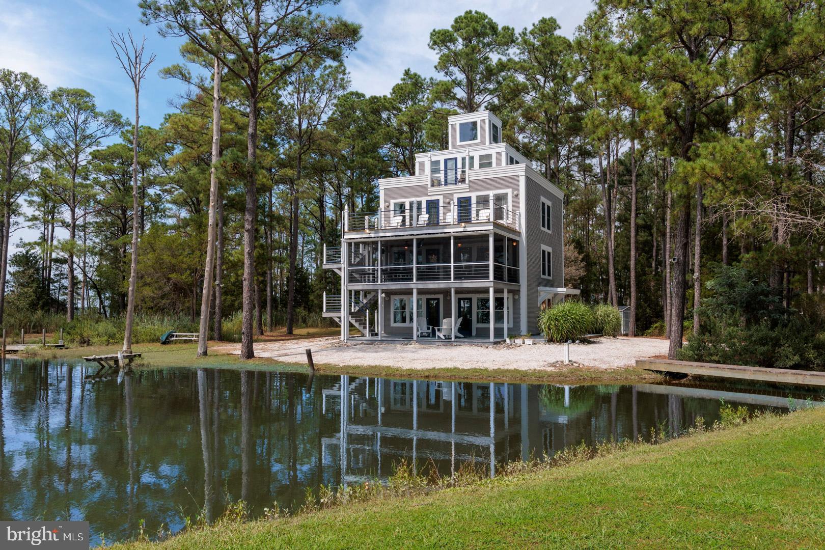 Custom design inspired by classic lighthouses and the beauty of the Chesapeake Bay, this 5 Bedroom, 4.5 Bath home offers 2,740+/- sq ft of living space on a private 4+ acre point with over 1,000 feet of shoreline. With dramatic westerly views and unmatched sunsets, the property combines privacy, water access, and natural beauty in one rare package. Outdoors, you’ll find a private pier plus a saltwater pond that attracts eagles, osprey, and herons. Multiple waterside porches and decks across four levels—including a full waterfront porch and two waterview balconies—invite you to relax, entertain, and take in the ever-changing views of Fishing Creek and the Chesapeake Bay beyond. As part of the offering, the neighboring lot is also included, providing even more privacy and the convenience of your own boat ramp—making it easy to launch and enjoy days on the water. Inside, the home balances comfort and function with 5 bedrooms, 4.5 baths, and abundant storage on the ground level for all your boating and outdoor gear. Whether you’re seeking a year-round residence or a weekend retreat, this property delivers the Eastern Shore lifestyle at its best: private, natural, and unforgettable.