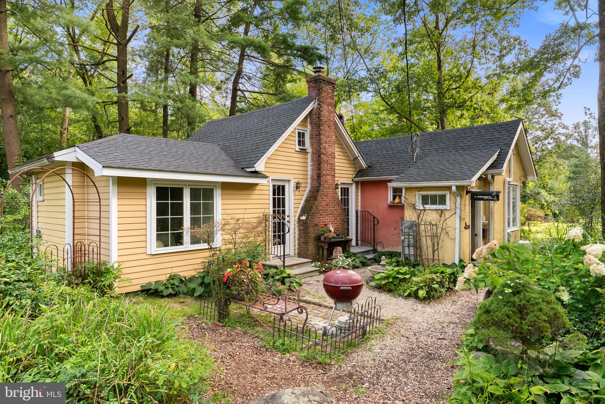 Tucked away on nearly 3 private acres, this charming country cottage offers the perfect retreat for anyone seeking peace, character, and a touch of history. Built in 1945 and lovingly maintained, the home blends timeless charm with thoughtful updates. Step inside to a welcoming foyer that opens to a spacious dining area filled with natural light and flexible enough to serve multiple uses. The kitchen is bright and open, featuring high ceilings, a double oven gas range with air fryer and self-cleaning functions, a stainless steel refrigerator, double sink, and a cozy coffee bar. Just off the kitchen, a hallway leads to a full bath with shower, a storage closet with a newer gas hot water tank, and the inviting living room where a fireplace creates the perfect gathering spot for family and friends. A loft area adds additional versatility, while the main-level bedroom offers ample closet space with a washer/dryer hookup for added convenience.
While the inside charms at every turn, the outdoor setting is truly special. Nearly 3 wooded acres provide endless possibilities—whether you envision gardening, keeping chickens, or simply enjoying the peace and privacy. Two large sheds offer great storage or space for hobbies, while the property itself invites creative expansion and outdoor living. Important updates include a new roof and Hardy Board siding in 2019, updated electrical system, and two efficient mini-splits providing both heating and cooling. With a one-year APHW home warranty included, this cottage offers both comfort and peace of mind. A rare gem brimming with potential and character, this little piece of heaven is ready for its next owner to enjoy. Don’t wait—schedule your visit today!