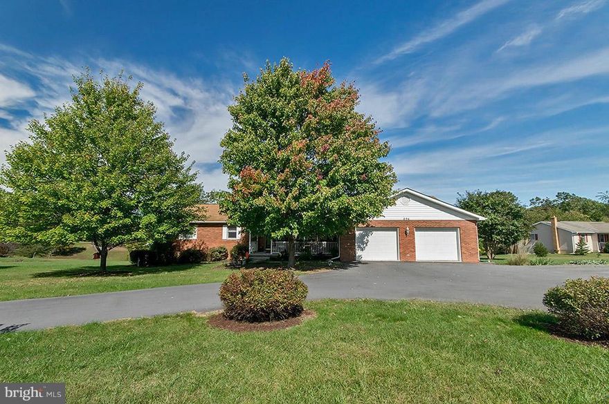 Brick rancher located in well maintained S/D just minutes from downtown Berkeley Springs & new hospital.  Front porch + deck for  evening relaxation.  Many amenities including, wood floors, Sun Room, Kitchen/DR/FR combo w/  WB Fireplace + Wood stove in the partially fin. walk out basement, fenced back yard, Intercom system, 2 car garage, paved roads.