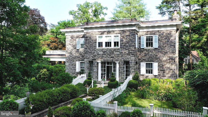 Welcome to 125 Bleddyn Road! This stately stone estate was built in 1907 to replicate a Venetian palazzo.  No detail was spared in the creation of this masterpiece of a home, nestled on a quiet street in Ardmore Pennsylvania.  The estate sits on almost a half acre of park-like manicured landscaping boasting wild-flowers, topiary trees and specimen plantings all surrounded by a cottage style picket fence.  Two side patios offer al fresco dining, one stunningly covered with accent stone pillars for entertaining in any weather. This owner has preserved all of the homes original details including wainscoting, stone and wood mantle fireplaces, curved staircase, hardwood flooring, french doors, lovely back staircase and so much more. Recent updates include a new roof with copper flashings (2022), new boiler (2022), generator, new carpet in rear bedroom. This over 6,000 square foot home boasts 5 large bedrooms, some with direct access to the enormous roof balcony with original balustrade spindles, and three full bathrooms. Soaring ceilings with arch details lead you through the u-shaped second floor while light flows in from every angle.  As you walk through the gates and up the stone walkway, you know you are about to enter a world preserved in time yet with all the modern amenities. Bleddyn is simply an entertainer's dream. The spacious kitchen has a separate pantry and laundry/mudroom area and a quaint closet/powder room that needs to be seen to appreciate.  And to top it all off, you can WALK to  Suburban Square, ride the Septa AND Amtrak train lines which has service direct to New York City and tons of restaurants and nearby shopping. This is truly a once in a lifetime opportunity to own a piece of history right here on the Main Line.