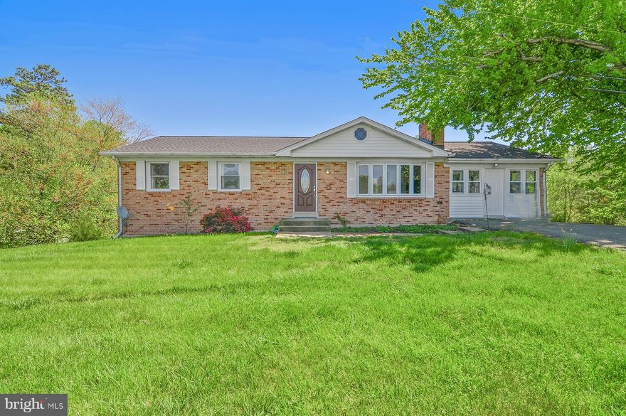 Are you searching for the perfect quaint farmette? This amazing opportunity presents a well-maintained rambler nestled in a peaceful countryside setting, on a fantastic nearly 2-acre lot! Numerous updates have been made, including a new roof, HVAC, and water softener. The house is highlighted by a charming large sunroom with A/C and a wood stove, hardwood floors, two main-level bedrooms, and a full bath. The table space in the main-level kitchen and dining room provide ample space for cooking and hosting. Downstairs, you'll find a wet bar/summer kitchen, a recreation room, two bedrooms, and an updated full bath. Step outside to your serene oasis, complete with a deck and patio, and a stunning in-ground pool, perfect for entertaining. The property also boasts a one-acre fenced horse paddock with one stall, a quaint chicken coop for fresh eggs, and plenty of room for parking. Conveniently located near AAFB, 495, and fantastic shopping, this picturesque country-living dream can be yours!