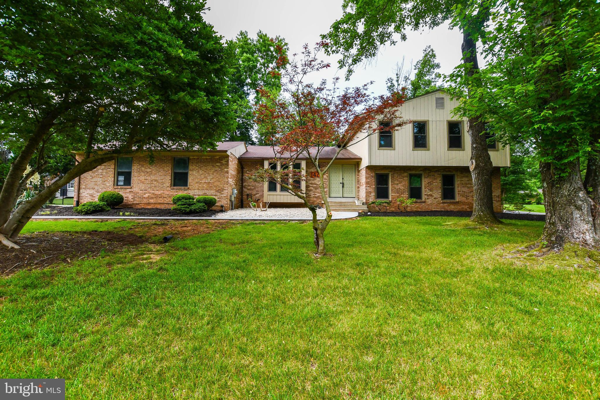 Welcome to Paradise Acres! This home is a total surprise! This home may NOT look brand new, but it is on the inside, check for yourself! Step into a meticulously redesigned and fully renovated two-car attached garage, a 4-level brick split that combines style, size, and modern luxury in one unforgettable package. Set on a peaceful, tree-lined street in Paradise Acres, this home offers over 3,000 square feet of finished living space, multiple living zones, and high-end upgrades throughout. The main level is an entertainer’s dream: walls have been opened to create a light-filled, open-concept layout uniting the living room, dining room, and showpiece kitchen. You’ll love the luxury hardwood floors, elegant recessed lighting, and flow that just makes sense. The designer kitchen is straight out of a magazine, featuring exotic granite countertops, sleek white modern cabinets, high-end stainless steel appliances, a deep farmhouse sink with a gooseneck faucet, and a peninsula with bar seating. Add custom backsplash, under-cabinet lighting, and you’ve got the perfect blend of form and function. Upstairs, you’ll find oversized bedrooms, including a massive Primary Suite with a private sitting area or office, walk-in closet, and a jaw-dropping spa bathroom. Think double vanities, dual showerheads, and luxurious tile and fixtures throughout. All three bathrooms in the home have been professionally designed & executed by a master tile installer with exceptional materials, some of which include brass fixtures, custom vanities, and designer tiles that will exceed the most discriminating expectations. The ground-level basement (not below grade!) features a huge family room with a cozy wood-burning fireplace, a private bedroom with a walkout slider, full bath, and dedicated laundry room. The lowest level is a flexible bonus space perfect for a home gym, theater, game room, or creative studio—with its own walk-out rear entrance to a sun-soaked backyard and brand new concrete patio. Other notable upgrades include all-new HVAC, washer & dryer, new LED lighting, outlets, switches, and modern fixtures, freshly painted inside and out, newly updated exterior with brick and siding, extended asphalt driveway for off-street parking,. Enjoy the peaceful privacy of the backyard while remaining just minutes from Watkins Park, Woodmore Town Center, shopping, dining, and commuter routes. Easy access to DC, Northern Virginia, Joint Base Andrews, NSA, NASA, and Fort Meade. Looking for long-term tenancy with strong credit. No pets, no smoking preferred. This one is move-in ready and built to impress—come see it for yourself!