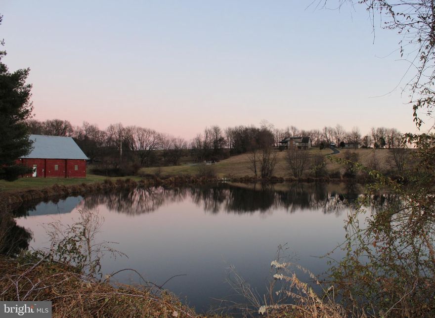 From the moment you enter the stone entrance, this 21+ acre offers Quiet Country Living.  This enchanted retreat offers unlimited potential with the peace and tranquility that you deserve.  This one-of-a-kind gem offers privacy, freedom, and tranquility as you enjoy 360-degree views of pastures, woods, mature trees, trails, abundant wildlife, running stream.  Enjoy hunting or fishing out of your own stocked pond.    It's like having our own private park.  There is NO HOA, zoned Agricultural so your horses and farm animals are welcome with acres of meadows that would make great pastures, orchards, or vegetable gardens, with room to grow with a future building right.  Work where you live with the limitless possibilities this property offers.  Bring your toys, plenty of parking.  Large red barn 60x100 has concrete floors, electric, bathroom and wood shop in loft.  Second barn is a block building, both barns have direct access from the road.  Which make them perfect for farming, animals, storage, or a business.  
This 5-bedroom, 3 full bath home has an open floor plan with beautiful real hardwood floors throughout the main floor.  It's a 3-story home that offers all the conveniences of one floor living. The Master bedroom and bath, kitchen, dining room, living room. laundry room, additional bedroom and bathroom are all on the main floor. The upper floor has an office/bedroom with balcony overlooking the living room with room for to add 2 more rooms.  Lower level has 2-bedrooms, bathroom, family room, wet bar and rec/game room.  This space is great for a large family, Entertaining, or an In-law apartment with lots of natural light with windows in every room as well as many walk outs.  Home features large, updated kitchen with new ss appliance, solid wood cabinets, hardwood floors, custom island, recessed lighting, under cabinet lighting, etc.  You will love the open floor plan as it flows from kitchen, dining to living room.  You will love the gorgeous real stone fireplace, cathedral ceilings and wood beams.  But don't forget the views.  You can enjoy them from almost every room in the house, wither you are looking out a large window or doors taking you to your private balcony, deck or patios.  You can watch the Bald Eagles fly overhead as the deer run across the meadow from your private balcony off the master bedroom.  Enjoy your oasis, the large master bathroom with double sinks, whirlpool tub and walk in closets.   You will call this custom-built house HOME!