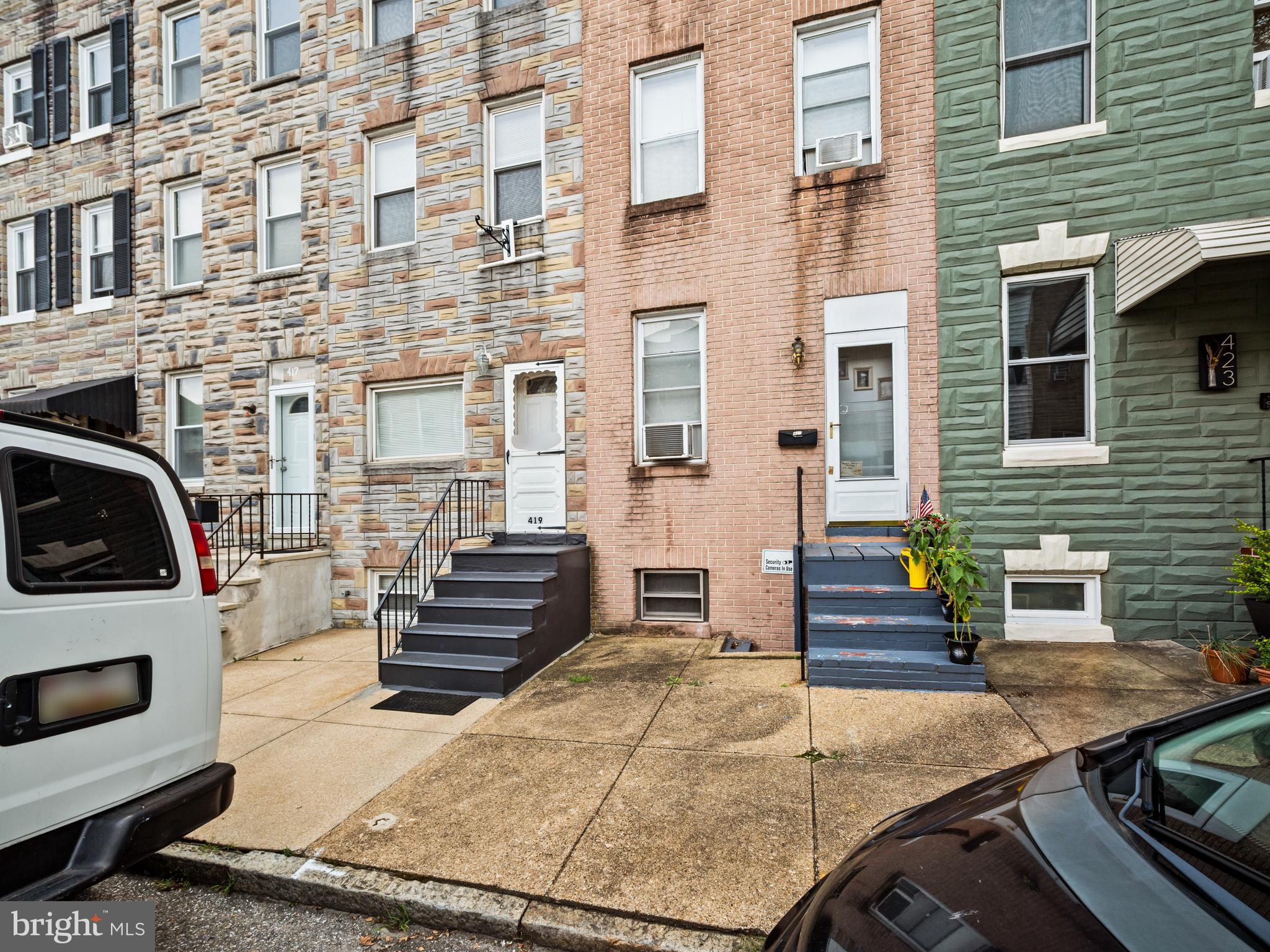 Welcome to this charming and spacious brick-front townhome nestled in the heart of Baltimore. This beautifully maintained property offers a perfect blend of classic character and modern updates across multiple finished levels. Step inside to a bright and open main living area with neutral paint, plush carpeting, and plenty of natural light. The formal living and dining rooms create a welcoming space ideal for relaxing or entertaining guests. The eat-in kitchen features warm wood cabinetry, ample countertop space, and modern appliances – a functional space ready for your culinary creations. Upstairs, you’ll find generously sized bedrooms with deep closets and updated lighting, along with well-appointed bathrooms featuring ceramic tile finishes and updated vanities. The finished lower level offers additional living space, perfect for a family room, office, or guest area, complete with a laundry/utility area and full bath. Enjoy outdoor living on the rear deck or in the private fenced-in backyard with parking pad access – a rare convenience in the city! Additional features include a lower-level walkout, central heating, and a neutral palette throughout, making this home move-in ready. Located just minutes from Johns Hopkins University, major commuter routes, local parks, and dining, 419 W 23rd St offers comfort, flexibility, and city living at its best. Don’t miss your chance to make this well-loved home yours!