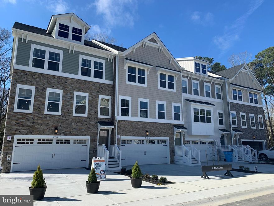 November delivery!! New Lennar Designer Select Townhome with 4 finished levels and all the features one could ask for!!  The kitchen boasts a stunning color palette, with stainless appliances, 2 wall ovens and a 5 burner cooktop! The home offers 3 full baths and 2 half baths, 1 deck, granite in kitchen and owners suite, 4th floor loft, 3 large bedrooms, wide plank floors on second level, 2  car garage with the opener included, gas heat,  and is a water oriented community; all wrapped in a warm and inviting vinyl and stone exterior!! Waters landing is stunning.  Photos are for illustration purposes only.