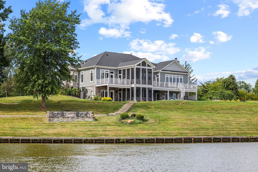 Waterfront Lake Living at it's Finest!!! Approximately 500' of Shoreline!  This Prestigious Home is Custom Built with  Hardie Plank Siding & Stone Showcases Tons of Upgrades, Luxury in ground pool and Features almost 5,000 Finished Sq. Ft Nestled on 5.5 Acres! 5 Bed/4 Full Bath, Hardwoods, Laundry Room on Both Levels, Attached 2 Car Garage w/Separate Golf Cart Entry, Gourmet Kitchen and Open Floor Plan. Main Level Living w/10' Ceilings! Kitchen is a Cooks Dream w/ all Stainless Steel Appliances, Gas Cooking, Double Oven, Quartz Countertops, 8' Cabinets, Prep Sink and Island. Primary Bath w/ Trey Ceilings and Gorgeous Ensuite. Soak Tub, Shower Stall, Double Sink, Granite Countertops and Custom Tile Work. Screened in Porch off Kitchen for Additional Dining and Breathtaking Views. Additional Bedroom and another Full Bath on Main. Lower Level Features 9' Ceilings, Bonus Room/Family Room, Pool Table, Ping Pong Table, 1200 Bottle Wine Cellar, 3 Full Bedrooms/2 Full Bathrooms, Walk Out to Volleyball, Basketball, Hot Tub, Extensive Hardscaping to Fire Pit and Amazing Dock!! 13 Zone, 2 Acre Underground Irrigation System w/Remote Access. 1500 Gallon Underground Propane. Flagstone Walkway, Brushed Concrete LED Lit Steps to Boathouse with Hardie Plank and Composite Flooring! Electric Lift for Boat and Jet Ski 's. All Interior and Exterior Furniture Conveys. This Luxury Lake Anna Home is the Perfect Investment Property for Vacation Rentals, Full Time Family Home or Weekend Getaways! Just Minutes to Restaurants like Tim's and The Cove! Not to mention this property comes fully furnished!!! What you see in those extravagant photos is what will come with the home!! Don't miss out on this killer opportunity!