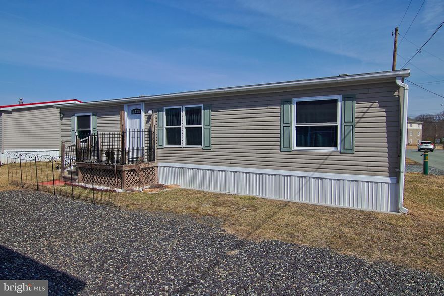 Affordable at last! This well maintained 30x47 double wide manufactured beauty has been recently renovated. Upgrades include newer roof, newer windows, newer doors, new decks, newer skirting, new appliances and more!!! This home has larger off-street parking for 4 cars! Enter into the mudroom from the rear deck. You will find a convenient laundry and utility area. The spacious kitchen with white cabinetry opens into the dining area and the large living room. On one side of the home is the owner's suite bedroom with double closets and private full bath with shower. On the other side there are two bedrooms and another full bath. One of the bedrooms is currently being used as storage. The seller has taken care of all of the big ticket items. Nothing to do but move right in! Best spot in the community with open space right beside you! Did you see the SUPER LOW taxes? Wow! Lot fee includes water, sewer, and trash. Purchase this home in award-winning Owen J Roberts School District for less than the cost of rent!