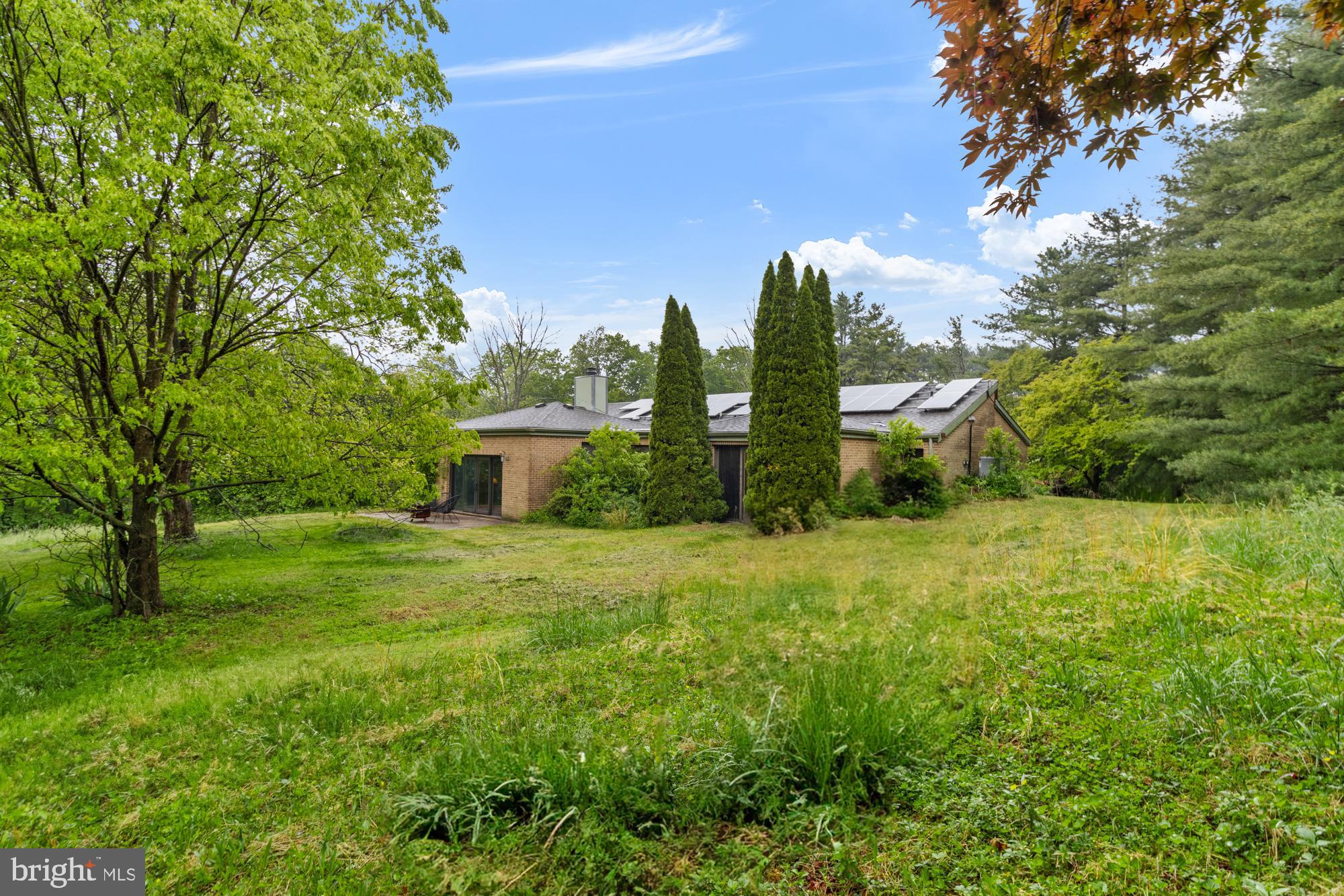 Back on the market! Buyer was unable to close! Mid-Century flair designed by a noted architect Donald Lee Sickler, a modernist architect in the firm of Mies van der Rohe, now ready for your viewpoint. Highly livable floorplan for today’s lifestyle, priced for needed repairs and updates. 2980sf above grade finished square feet plus beautiful potential in the lower level with high ceilings and a huge brick hearth fireplace.
The floorplan lives like it was made with today’s wish lists in mind! Primary suite bath offers a huge walk-in shower. There’s a large mudroom entry off the garage with room for everything you’d ever like to have at your fingertips on the way out the door. The laundry room is it’s own sunny space, not a closet or a hallway doubling as the mudroom! The office is designed and located to enjoy outside views as well as feel like a comfortable part of the house, and could easily be pressed into service as a guest room.
The lot is 3.03 gently rolling acres with fabulous views, and works well for those who would like multiple options for how and where to entertain, garden and play. Be sure to check out the 2 sheds and greenhouse, too. The solar panels are owned outright. Main roof replaced 2021, hot water heater 2024, lower driveway paved 2024. Some repairs are needed, and the home is priced accordingly - seller will not make repairs.