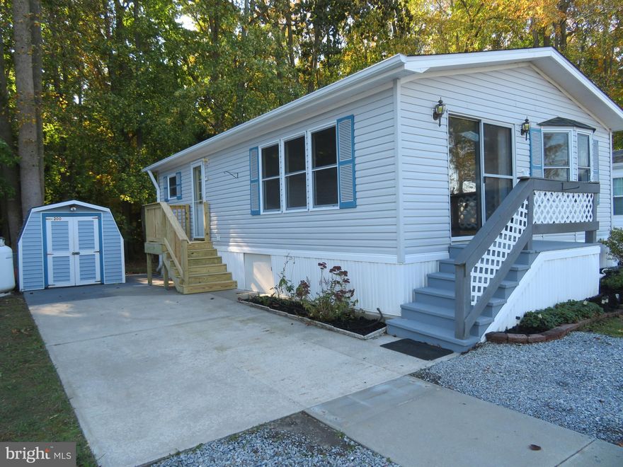 OWN YOUR VACATION SPOT/2nd home on the Eastern Shore approximately 10 minutes to Ocean City beach & boardwalk. OWN LAND & BEACH COTTAGE STYLE HOME. NO GROUND RENT. NOT A RENTAL. Only has had one owner and has been a non smoking  home with no pets. RARE FIND AT THIS PRICE FOR A COTTAGE STYLE HOME. LOTS OF COMMUNITY AMENITIES (Ice cream socials, coffee & donut mornings, bingo, community yard sale, crab feast) & many more.  Location on preferred wooded perimeter of park allows privacy in rear of home , serenity & touch of natures natural beauty  from master bedroom (no homes behind you). 2 bedroom. 465 privately owned homes located in 24 hr. private security/gated ST. MARTINS RIVER waterfront community. Large in ground pool & clubhouse just a stones throw away. Close to 2nd entrance for quicker access. Public water/sewer $49. monthly, cable is $207.89 every 6 months. Included in $116. monthly home owner assoc. fee,  free trash removal,  clubhouse, pool, boat ramp, (small $75. sticker fee for fenced in storage area for boats, boat trailers/jet ski & area to clean your boat). River front marina, piers with boat slips (some slips for daily rentals). Boat slips are $550. for a season. Crabbing gazebo & area to clean your fish . Basketball, tot playground for kids. canoe/kayak racks, picnic tables and grills, 2 bath houses with full showers and bathrooms to rinse the sand off your feet from the beach. 2 laundry rooms. Best of all the park cuts your grass. Freshly painted 10/2023. Gas corner fireplace for those chilly evenings. All appliances included.  Full size washer/dryer, built-in microwave w/splash guard, garbage disposal, gas range and dishwasher. NEW  ROOF & SKYLIGHTS  (2006), HVAC has been replaced (6-27-22), 3 ceiling fans. Brand new LVP flooring Oct. 2023. Recessed lighting and lighting under large breakfast bar & above & below kitchen cabinets. Breakfast bar, kitchen & bath with silestone countertops. Shed has electric. Home also has concrete slab built underneath for additional storage. 2 entrances both front slider and side of home also has storm door w/retractable hide-away screen. Brand new side entrance porch and stairs (Nov 1, 2023. Home is sold unfurnished. Overflow parking for extra guest just doors away. Hop, skip & jump to many restaurants, shops & casino. Across street from park has walkway to weekly farmers market, craft shows & bands under a pavilion, large playground during some seasons. SOLD AS IS- owner does not know of any latent defects in the home except water & ice dispenser never used.  Home in good shape and needs very little TLC to make it your own. This is an excellent price for a cottage style home.  Please note there are some limited restrictions as to when you can stay in park during winter months. There is off season occupancy use per county code. Full time use April 1-September 30th. 60 days total use from October 1-March 31 with a 30 consecutive day max. Ask listing agent or park manager.  Park is open 365 days. Must enter park w/REALTOR by signing in at either office or security gate. Office is open 8am to 4pm except closed on Sunday. When office is closed security guard is at gatehouse in front of office.