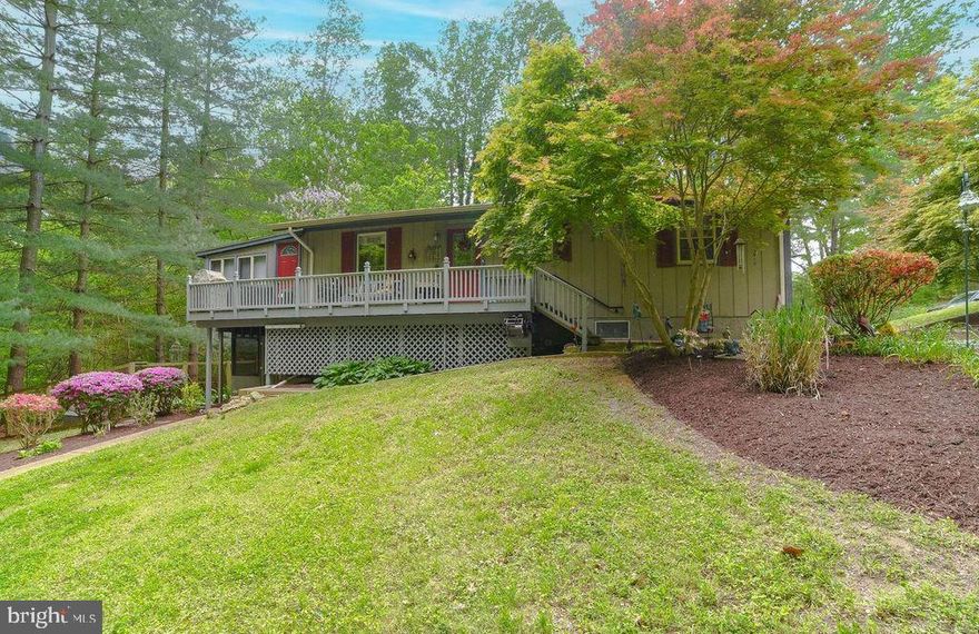 Charming rambler located on a 2.98 acre lot surrounded by mature trees, flowering plants and shrubs.  This home has 4 bedrooms and 2 full bathrooms.  Open concept living room, dining room and kitchen have vaulted ceiling with exposed beams and a fireplace.  Sunroom off main living area provides great space to relax and enjoy the surrounding peaceful location.  Primary bedroom with walk in closet and door which opens to the sunroom.  Two additional bedrooms and a full bathroom on the main level.  The basement includes a rec room with fireplace, laundry room, full bathroom and a bedroom.  Access to the screened porch and garage are on the lower level.   Exterior has a fenced in area and 3 outdoor sheds.  Close to local restaurants, shopping and schools.  Easy access to route 235 for commuters going both north to Washington DC and Northern VA or going south to PAX Naval Air Station.  Schedule your online appointment today.