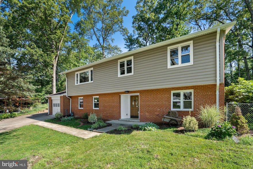 Gorgeous move-in ready home in Sedgewick Forest! Enjoy this peaceful wooded lot on a cul-de-sac with NO HOA! Entry level features a large bedroom, which makes the perfect guest space or home office, and a light-filled den with welcoming fireplace. Upstairs you'll find newly finished hardwood floors throughout, as well as vaulted ceilings and wood beams in the main living area. Beautiful white kitchen with granite countertops and stainless steel appliances opens to the dining space and family room. Three spacious bedrooms on upper level, including a large master with ensuite bathroom! Sunroom leads out to the giant back deck overlooking a private, low maintenance backyard. One car garage that adjoins to a workshop, perfect for storage or for woodworking! Roof, gutters, siding, soffits, and HVAC all replaced in 2016! Convenient to the Pentagon, Ft Belvoir, Old Town, and DC - don't miss it!