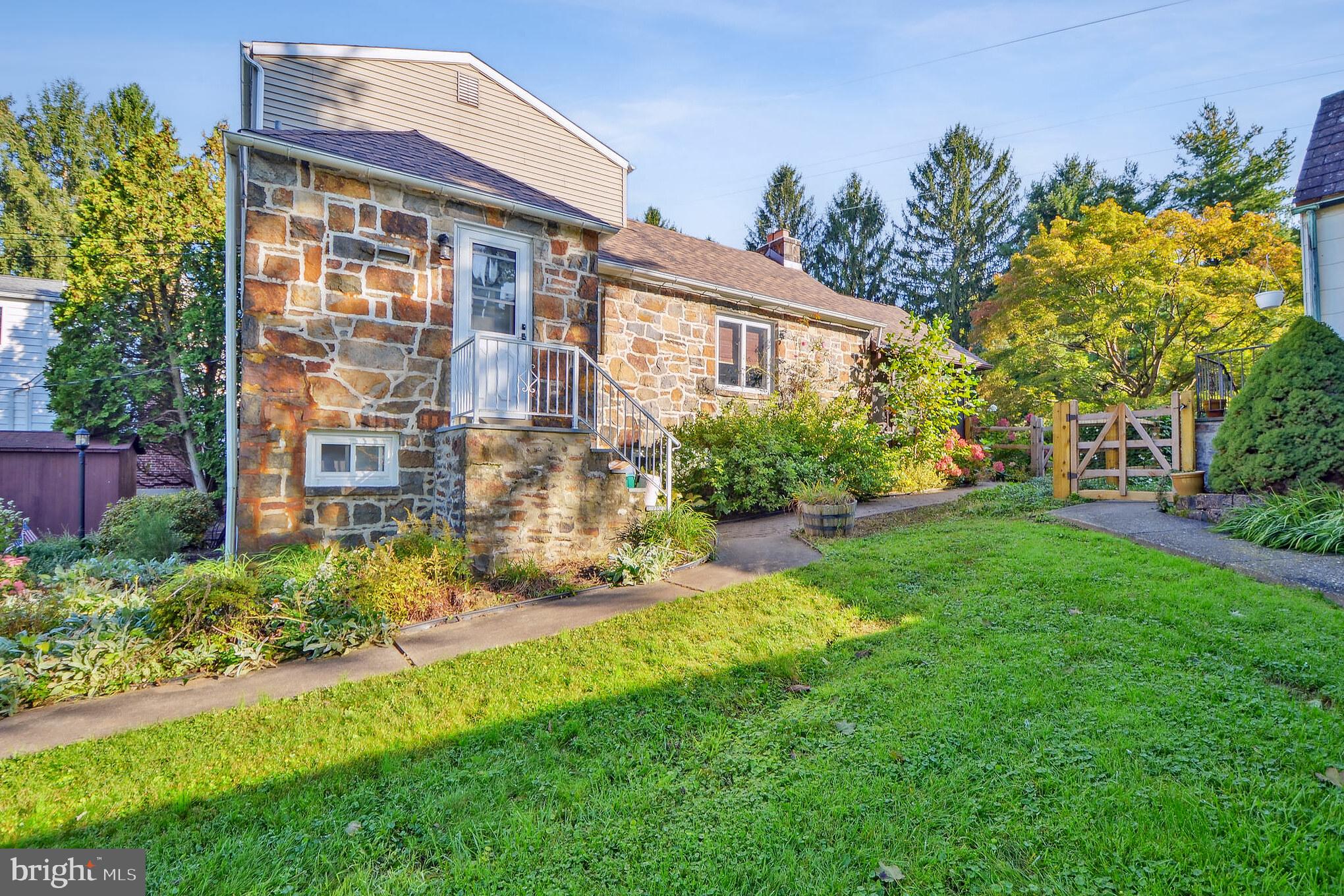 Welcome to this craftsman stone cottage situated on a serene park-like lot. The living room area features a wood beam cathedral ceiling, impressive stone fireplace, built-in cabinets and plenty of natural light. Adjacent to the living area is the kitchen and dining area as well as a side door entrance. The main floor also includes two bedrooms and a full bathroom. An elegant wood staircase leads to a dutch door and entry to the primary bedroom. Characteristics of the spacious primary bedroom include a high ceiling, built-in bench, walk-in closet and a half bathroom. Wood floors throughout the home. This description wouldn't be complete without mentioning the screened in porch, wood deck and a fully fenced backyard area. A nature lover's dream! Enjoy the outdoors spring, summer or fall in a relaxing and cozy setting. This home also features a clean basement with direct access to a one-car garage. Ample outdoor parking space as well. Come see this one of a kind Bethlehem beauty!