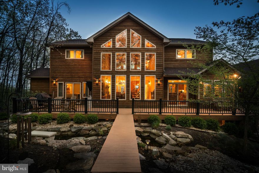 This LUXURIOUS CEDAR AND STONE contemporary is designed for complete lifestyle living. The Woods Resort offers many amenities including golfing, but the home offers ALL of the upgrades one expects in an exclusive home. Brazilian hardwood floors, stone 2 story fireplace, jetted MBth w/sep walk in shower, theater room w/projector and screen, sauna, gated and so much more sitting on top of the world.