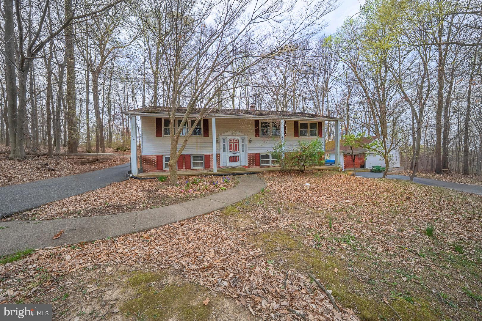 Located in the Award Wining Downingtown Schools & S.T.E.M. Academy. Tucked down a private lane on an acre of properpty. Three Bedroom Bi-Level with a lot of potential for the future buyer(s). Open Living Room to Dining Room, Slider to Deck. Eat-In Kitchen, Sink with Side sink, Electric Range, Pantry, Ceiling Fan/Light. Pull Downstairs to partially floored attic. Full unfinished basement with outside door to the three car detached garage. Great garage for the car buff. Being Sold "As-is", buyer(s) responsible for Use & Occupancy Permit from Township. Great opportunity to live on an acre of property in Downingtown. Conveinently located to Rt. 30 By-Pass, Minutes to Downtown Downingtown, Lionville Shopping Center, Wegmans, Septa Rail System and much more.