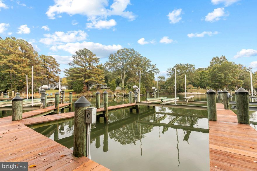 Calling all boaters!! Gorgeous  waterfront Colonial in Solomon's in  Premier Point community with boardwalk, shared pier, dedicated boat slip with 12,500lb boat lift.  Enjoy quiet evenings on the deck and observe the wildlife from the river/creek.  This energy star home features 9 foot ceilings and tons of beautiful natural light.  Plenty of space for everyone with 4 full bedrooms and 4 full baths as well as a main level office that can function as an additional bedroom.  Gleaming blonde wood flooring and beautiful trim work adorn this Willow Floorplan built by QBH.  Come home to enjoy the waterfront lifestyle, and take a quick boat ride to Solomon's Island for dinner!  This home has been meticulously maintained by the original owners, has a finished garage and is move-in ready.  Natural gas and low utilities are bonuses in this fabulous home.  This home features over $60K in builder upgrades , a cozy gas fireplace and the lush lawn has an irrigation system as well.  Large basement area for recreation room, theater room or family area.  Full basement bathroom and interior storage as well as workshop area with additional 60 amp sub panel.  Beauty, comfort, location and lifestyle....this home has it all!  Book your showing today!
