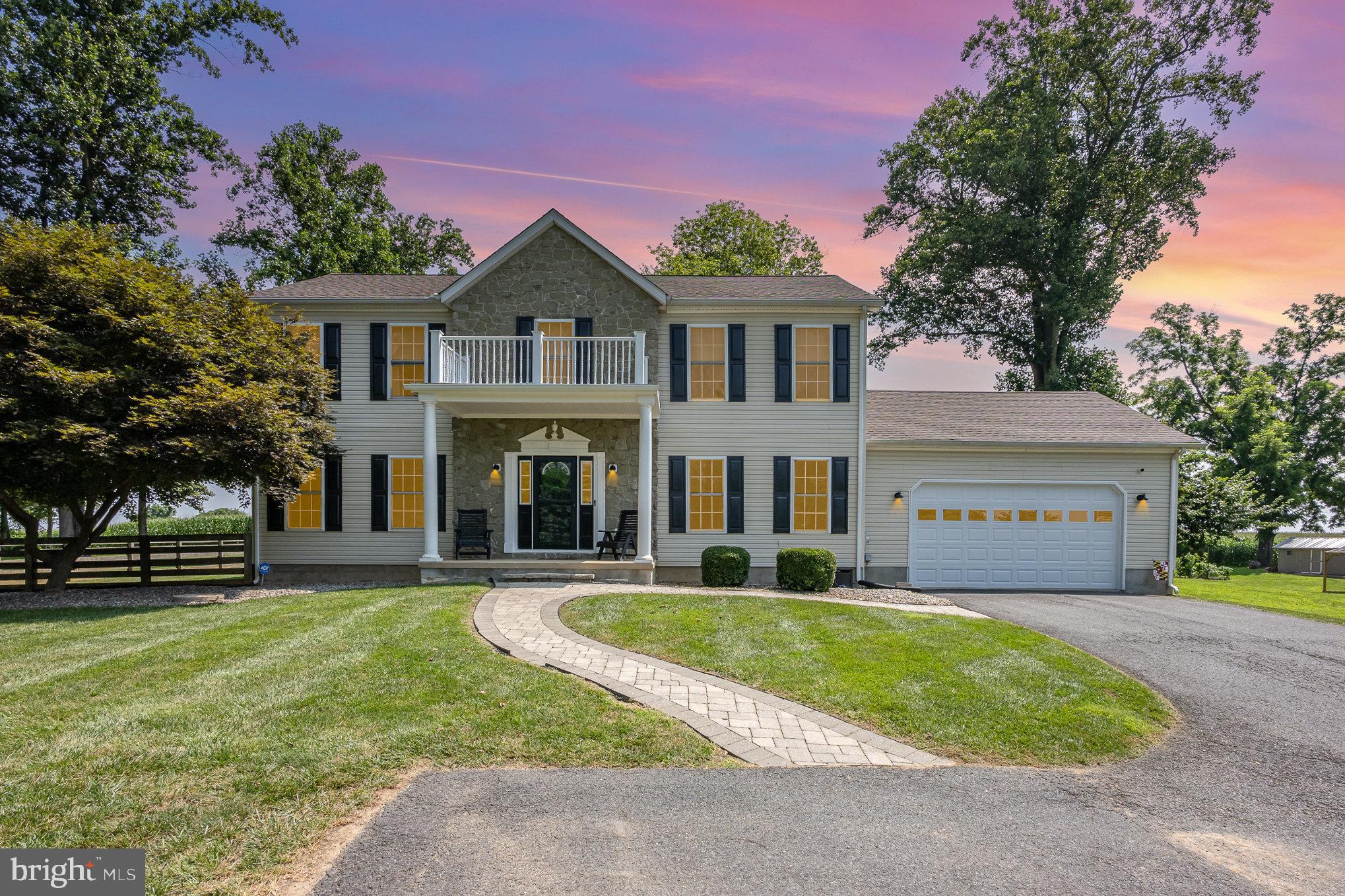 Impeccable Colonial Backing to Farmland. Welcome to this stunning 4-bedroom, 2.5-bath colonial nestled on a picturesque 0.92-acre lot. No HOA! Beautifully maintained! A curved driveway leads to a stately columned front porch and custom paver walkway, setting the tone for timeless elegance and curb appeal. Front balcony is the perfect location for your holiday decor! Sit on your front porch and enjoy the view! A horse farm is located across the street.
Inside, the heart of the home is the incredible kitchen, featuring custom Kraftmaid Pewter Glazed cabinetry, Corian countertops, and thoughtful upgrades throughout. Kitchen adjoins the living and dining areas for easy entertaining. Hardwood floors and custom moldings add warmth and character, while the spacious layout offers both functionality and flow.
The upstairs offers an owner's suite with a walk-in closet, adjoining primary bathroom with an incredible custom, recently updated shower! Closets have organizers to add more storage space!
The full basement is an open slate ready for your vision—already equipped with a coated floor for protection and durability, it offers endless possibilities for additional living or recreational space. Steps lead to the backyard area.
Step outside to a large covered deck, perfect for entertaining, that steps down to an EP Henry patio surrounded by a fenced yard. Additional outdoor highlights include paver sidewalks, ample exterior storage or workspace with a 14'x14' shed and 12'x16' shed. Hate mulching? No need to worry, this one has river rock throughout for easy maintaining. The property backs to farmland.
Enjoy peace of mind with a basement waterproofing system, major updated components (5 -year-old) are dual-zone HVAC, and a roof. Attic temperature control fan for energy savings. The climate-controlled attached two-car garage and convenient main-level laundry add everyday comfort.
Located in the highly regarded Rising Sun School District (buyer to verify), this home truly has it all—charm, space, and quality craftsmanship in a serene setting. Convenience is not a problem for the location is near schools, shopping, restaurants and the towns of Port Deposit, Rising Sun and Perryville. Minutes to I-95, Route 40 and Route 1.
Schedule showings starting on Friday. Don’t miss your chance to make this exceptional home yours!