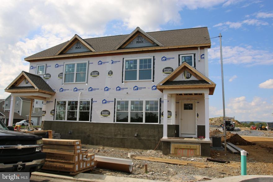The wide-hipped roof and the stone and horizontal siding profile adds pleasant curb appeal to this plan.   Open living spaces and generous bedrooms await inside.  The kitchen offers ample space for cooking and leads out to a 10 X 12 patio for relaxation or grilling. The laundry room next to kitchen makes multi-tasking easy. Downstairs has a full unfinished basement for extra storage space. Upstairs is a large primary suite with double bowl vanity and two more bedrooms sharing the hall bath.