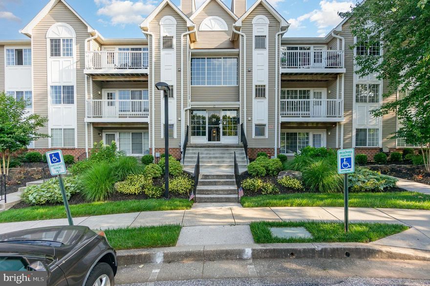 Sought-after Mays Chapel North, presents this stunning terrace-level corner condominium with secure building entry, over 1,006 sqft, 2 bedrooms, 2½ baths, exterior storage and gleaming hardwood floors throughout.  This open concept home features dual entries, a private covered patio entry  and an enclosed shared hall entry. The living room features a marble surround fireplace, bright and cheerful trio window and a walk out to the patio overlooking gardens, trees and trails. The kitchen provides ease of congregating where white cabinets and granite counters meet a curved peninsula for an updated cooking entertainment opportunity.  The stacked laundry center is adjacent to the kitchen and hosts recently replaced appliances. The primary suite hosts a walk-in closet, plenty of natural light, and a private bath with walk in shower.  Housemates or guests will appreciate the large second bedroom, guest bath and the cherrfiulness of this sunlit drenched unit. A modern low maintenance lifestyle awaits in this ideal location just minutes to trails, shopping, recreation, and commuter routes. A true opportunity.