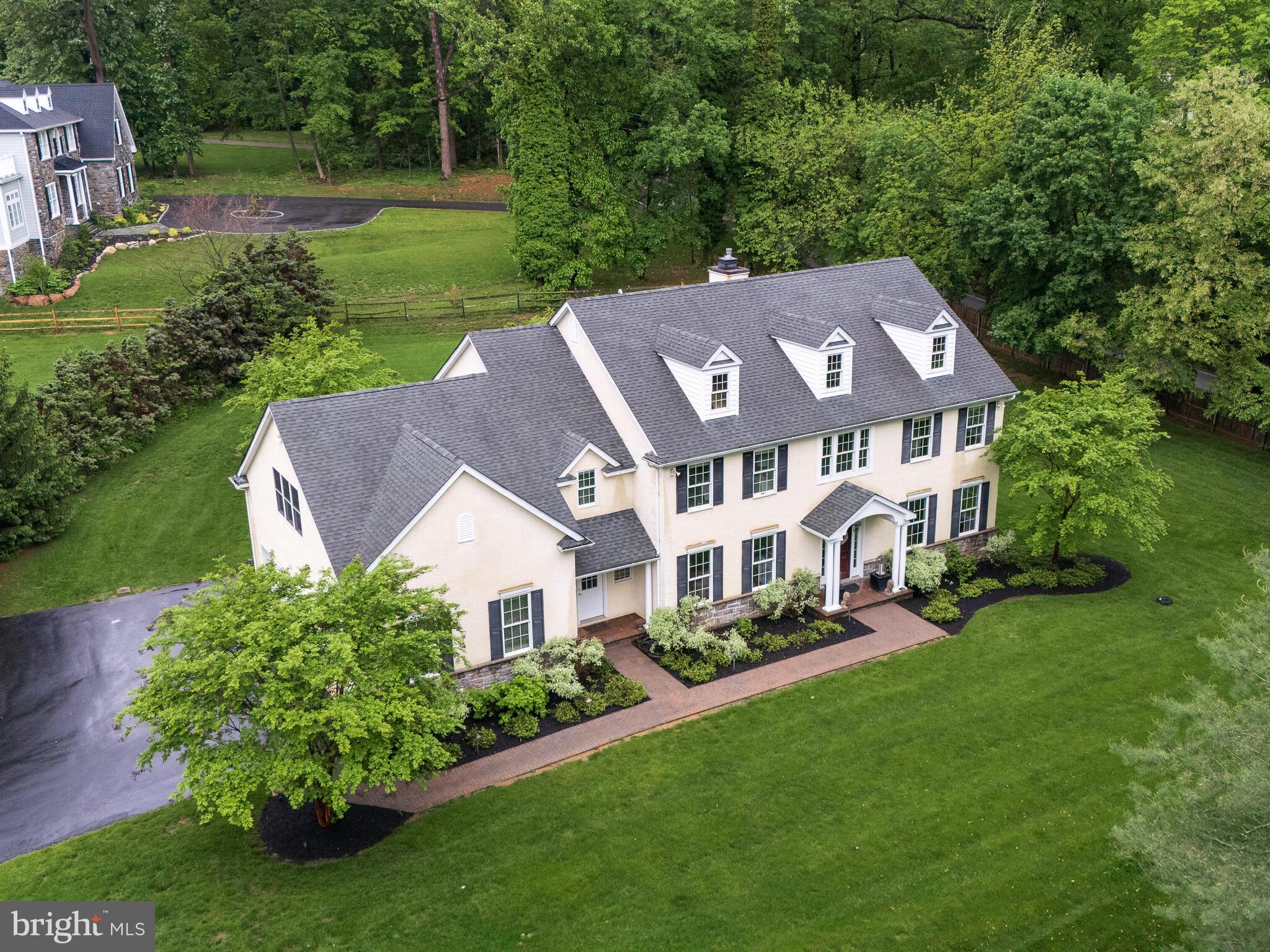 Welcome to 131 Devon Road, Paoli! This 4,593 sq ft, 4-bedroom, 4 full and 2 half-bath custom home, built in 2005, situated on .94 acres, offers elegance, thoughtful design, and premium finishes in one of the Main Line’s most sought-after locations. This home is located a quarter of a mile from the Paoli train station in the Tredyffrin-Eastown school district. The sellers have invested $230,000 + in upgrades during their ownership: HVAC replaced (2020), Hot water heater replaced (2024), Basement finished with second office, exercise room, fifth bedroom, full bathroom, large custom wet bar that seats 8-10 people, large open seating area, and a sizable, temperature controlled wine storage closet, and a separate large storage closet for holiday decorations, etc.(2014-2015), New stainless kitchen refrigerator, microwave and garbage disposal installed (2024-2025), Custom interior lighting installed (2014-2015), New exterior hardscaping, new custom landscaping, irrigation system, and custom landscape lighting installed (2014-2015). Grand open staircase with second floor overlook in the 2-story foyer. You will appreciate the attention to detail—wood floors, coat closets on either side of the front door, elegant custom crown molding, wainscoting and large windows offer natural lighting throughout. The open layout flows seamlessly from the living and dining room to the gourmet kitchen, which features granite countertops, custom cherry cabinetry, an oversized island with seating for four, a butler’s pantry that transitions between the kitchen and dining room, and stainless appliances and an open rear staircase to second floor. A breakfast room with French doors leads to a private hardscaped patio—perfect for indoor/outdoor entertaining. The large family room flows from the kitchen and features a cathedral ceiling, floor to ceiling windows with views of the backyard, recessed lighting and ceiling fan, and a gas fireplace. The private study next to the family room, features glass French doors and a wall of windows with views to the backyard. There are two half baths, one on either side of the main level. The laundry room/mudroom enjoys a second entrance in the front of the house from the driveway, and another door to the oversized three-car garage. The garage offers a large storage area in addition to the three bays and a separate door to the backyard patio space. Upstairs, the primary suite features a sitting area, his and hers, separate walk-in closets, and a spa-like bath with a whirlpool tub, oversized glass stall shower, a double vanity and a private water closet. The second level features three additional bedrooms and two additional full bathrooms – both bathrooms offer ensuite access to the adjoining bedrooms AND to the main hallway. Fenced rear and side yard, irrigation system and upgraded security system. Ideally located close to Main Line shopping, dining, and Paoli train station, this beautifully maintained home offers a rare blend of comfort, craftsmanship, and convenience. Welcome home....