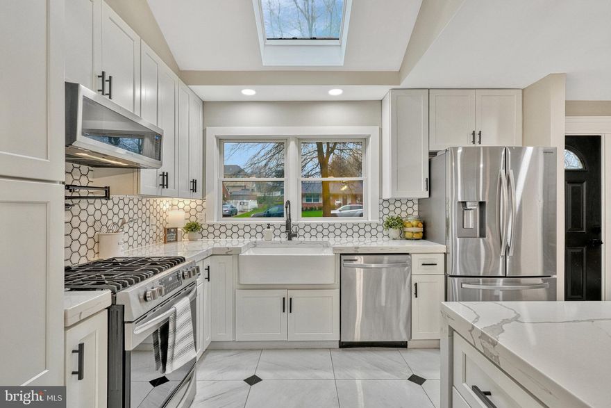 Welcome home! This bright and airy 5 bedroom home is full of stunning updates! Step inside the front door and you’ll fall in love with the gorgeously renovated kitchen. It features everything you’re looking for and more: bright Shaker-style cabinets, marble countertops, stainless steel appliances, a trendy backsplash and farmhouse sink, island breakfast bar, modern fixtures, and an impressive skylight.  Pass through into the dining room, a space large enough to host intimate family meals and large dinner parties. Continue into the living room, where you’ll find recessed lighting, a wood-burning fireplace with an attractive stone surround, and gorgeous bay window flooding the room with natural light. These beautiful hardwood floors lead you to the primary bedroom suite, which boasts an elegant en suite bathroom with a walk-in shower and custom tile surround. Two additional bedrooms on this level both include recessed lighting and wide closets. In the hall, the handsome updated bathroom boasts a stand alone soaking tub with shower, a wide vanity, marble tiles, and contemporary finishes. Downstairs in the lower level, the spacious light-filled rec room boasts luxury vinyl plank flooring, built-in bookshelves, and a second wood-burning fireplace. Two additional bedrooms can be found on this level, making them ideal for a private home office, secluded guest space, or home gym. The third full bathroom is sleek and includes a step-in shower with custom tile shower surround and a mid-century modern style vanity. Rounding out this level is a large laundry room with a utility sink. Step outside from the lower level and enjoy the large fenced backyard. The tree-lined property and stone patio with pergola are peaceful, private, and perfect for relaxing or entertaining. The extra long driveway gives you and your guests plenty of space for parking. Minutes to Giant, Safeway, H Mart, Springfield Town Center, Kingstowne Towne Center, The Block Food Hall, Lake Accotink Park and Trails, Mason District Park, and Audrey Moore Rec Center. Quick access to I-495, Braddock Road, Backlick Road, Little River Turnpike, Columbia Pike, and I-395. Schedule a private tour of your lovely new home today!