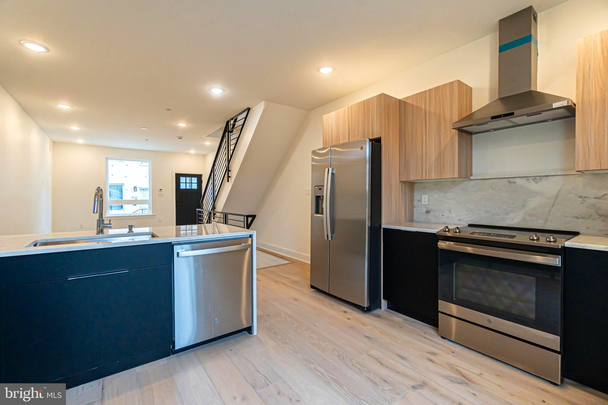 Welcome to your dream home nestled in the vibrant heart of Point Breeze, Philadelphia! This exquisite new construction seamlessly marries modern sophistication with timeless charm and is ideally situated at 1408 S Taylor Street. Spanning three spacious stories, this extraordinary home features three beautifully appointed bedrooms, three luxurious bathrooms, a finished basement, and a magnificent rooftop deck that offers sweeping skyline views. As you step inside, you're welcomed by an expansive and light-filled open floor plan, where natural light dances across the high ceilings and bright windows, creating an inviting atmosphere. The gleaming hardwood floors exude warmth and elegance, providing the perfect backdrop for both casual gatherings and refined entertaining. The layout allows for versatile living spaces, where you can create distinct areas for relaxation and dining. The heart of this home is the stunning gourmet kitchen, a culinary enthusiast’s dream. Outfitted with high-end stainless-steel appliances, lustrous quartz countertops, and generous storage options, this kitchen is as functional as it is beautiful. A wrought iron-trimmed staircase leads you to this sunlit haven, featuring shaker cabinetry and a stylish tile backsplash that enhances its contemporary appeal. Step outside to discover your private patio a tranquil retreat where you can escape the fast pace of city life. This outdoor space is ideal for hosting lively barbecues or enjoying intimate dinners under the stars during warm summer nights. As you ascend to the upper levels, you will find the luxurious main suite, truly a sanctuary of relaxation. The master bedroom offers a serene ambiance, complete with a spacious walk-in closet and a spa-like ensuite bathroom. Indulge in the soaking tub, pamper yourself at the dual vanities, and rejuvenate in the expansive shower. The second floor is also home to two additional well-sized bedrooms, ensuring ample space for family or guests. A conveniently located laundry area features a front loader washer and dryer alongside a full bathroom boasting a double vanity and a private rainfall shower.
The private rooftop deck is an oasis that invites you to enjoy breathtaking views of the city skyline. Whether hosting summer barbecues, stargazing on clear nights, or relaxing after a busy day, this outdoor retreat provides the perfect setting for creating unforgettable memories. Beyond its stunning interior, this exceptional home is strategically located in the highly desirable Point Breeze neighborhood. Explore a variety of top-rated restaurants, charming local shops, and lively markets just a short distance away. With easy access to public transit, Washington Ave, I-76, and University City, you’re ideally situated to enjoy both the peace of your home and the excitement of city life. Don’t miss your chance to experience this extraordinary living opportunity. One Year Builders Warranty included. Schedule your in-person or virtual tour today!