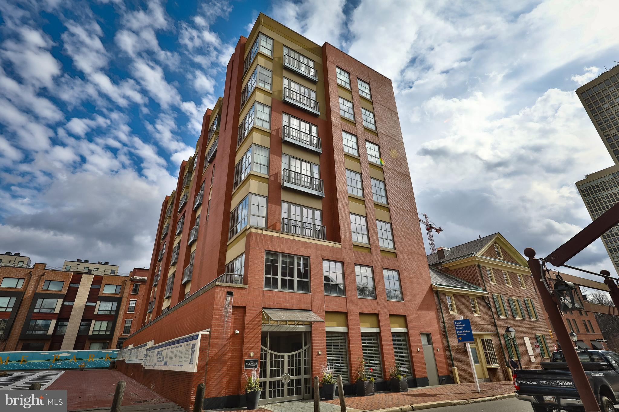 Don't miss this rare opportunity to own a gorgeous, spacious condo in a great neighborhood! The best of city living just outside your door. Occupying nearly 3,000 square feet of living space in a boutique building on the edge of Society Hill and Old City, this corner unit is truly a rare find. It comes complete with two car deeded indoor on-site parking, a world-class newly renovated kitchen, gas fireplace, 3 spacious bedrooms plus den and 2 and a half bathrooms. This unit has been meticulously cared for and thoughtfully updated with custom carpentry and shelving in the office and den. The renovated island kitchen anchors the bright and airy open floor plan and features granite countertops, top of the line appliances (Wolf 6 burner dual fuel range, Wolf steam oven and Wolf drawer microwave, Cove dishwasher and Sub-zero refrigerator) and thoughtful custom cabinetry with drawers for spices, knives, pots and lids, tray storage. At the other end of the unit, the master bedroom includes 2 large custom walk-in closets, a spacious bathroom with separate water-closet, tons of storage and a balcony overlooking historic Welcome Park. The third bedroom is currently utilized as a home office with a custom built out desk and storage. Additional features include: a separate laundry room with new full size front loading washer and dryer, 2 zoned heating and cooling, a new water heater and a storage room in the basement for additional storage. The Moravian is a lovely, secure doorman building just steps from great restaurants (Zahav is across the street!), theaters, shops, Penn's Landing, historic sites and parks, public transportation, the Ritz movie theaters, Headhouse Square, Washington Square, McCall Elementary and Middle School catchment and so much more. The building makes for easy living in the heart of the city. Schedule your showing today. This is a rare find and truly a must see!