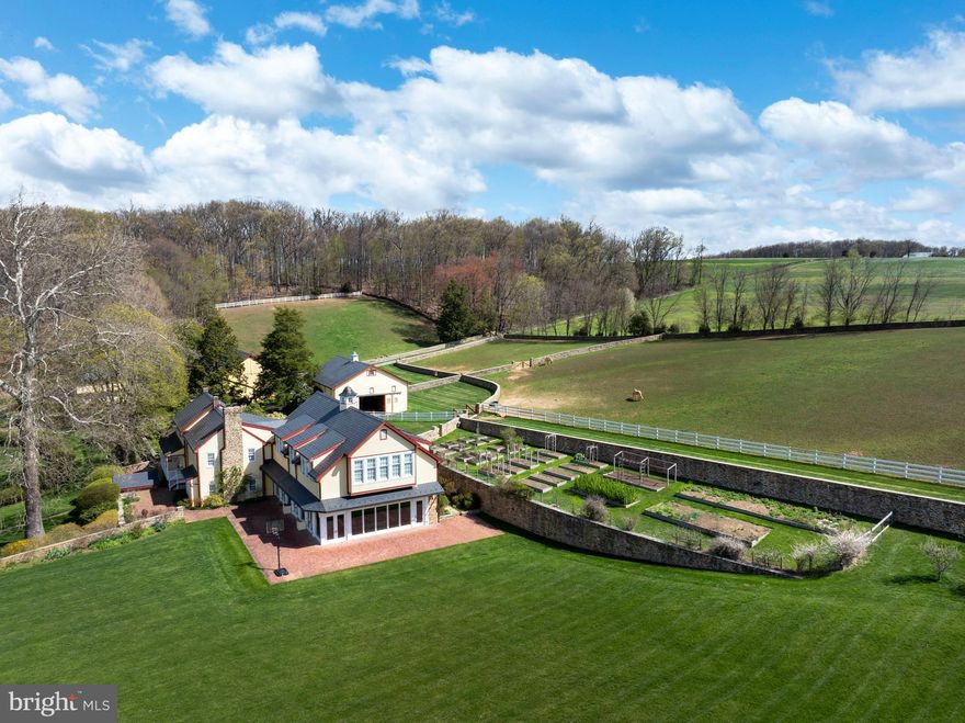 An incomparable equestrian estate unfolds across more than 41 pristine acres, blending the timeless character of a Colonial home with the elegance and functionality of a premier horse property. This captivating retreat features a beautifully maintained main residence, an 8-stall horse barn designed for the comfort and care of equine companions, a spacious bank barn, and grounds adorned with charming stone walkways, handsome fencing, and lush, manicured landscaping that seamlessly complement the natural beauty of the surroundings. As you approach, a large, beautiful pond welcomes you with serene reflections and a tranquil presence, setting the stage for the grandeur of the main house and barns beyond. Every element of the property reflects a commitment to craftsmanship, heritage, and lifestyle.

The main home radiates the sophistication of a country estate, beginning with rich hardwood floors that run throughout and set the tone for its warm, welcoming interior. The first floor is a showcase of high-end design and thoughtful detail. At its heart lies a gourmet kitchen outfitted with top-of-the-line stainless steel appliances, including a Sub-Zero refrigerator and a center island that hosts Wolf double ovens and an electric cooktop beneath a striking, commercial-grade pounded copper hood. Adjacent to the kitchen, the living room impresses with soaring vaulted ceilings, a cozy wood-burning fireplace, and abundant natural light streaming through expansive windows. The formal dining room exudes classic charm with detailed wainscoting, crown molding, and chair rails, creating an ideal space for memorable gatherings. For more relaxed entertaining, the billiard room offers another wood-burning fireplace, intricate architectural accents, and an inviting ambiance that is sure to please.

A true highlight of the residence is the indoor heated pool, bathed in sunlight and complete with a nearby full bathroom featuring a walk-in shower—perfect for year-round enjoyment. Upstairs, the second level continues to impress with a large, comfortable family room centered around a third wood-burning fireplace and soft carpet underfoot. The upper level boasts six spacious bedrooms, including three with their own en-suite baths. The primary suite is a serene retreat, offering a skylit sitting area with custom built-ins, dual walk-in closets, and expansive windows that frame tranquil views of the estate.

The finished lower level extends the home’s versatility, offering a complete guest suite that includes a full kitchen, an adjacent living room, a separate bedroom, and a full bathroom—ideal for extended guests, in-laws, or private accommodations. Outside, the front yard opens to a pavilion and generous open space, providing the perfect setting for hosting events, family gatherings, or quiet evenings beneath the stars.

With its ideal blend of refined living, equestrian functionality, and scenic charm, this estate offers a rare opportunity to own a piece of paradise. Whether you're a passionate horse enthusiast or someone seeking a luxurious country lifestyle, this property delivers exceptional beauty, comfort, and possibility. Schedule your private showing today to experience all it has to offer.