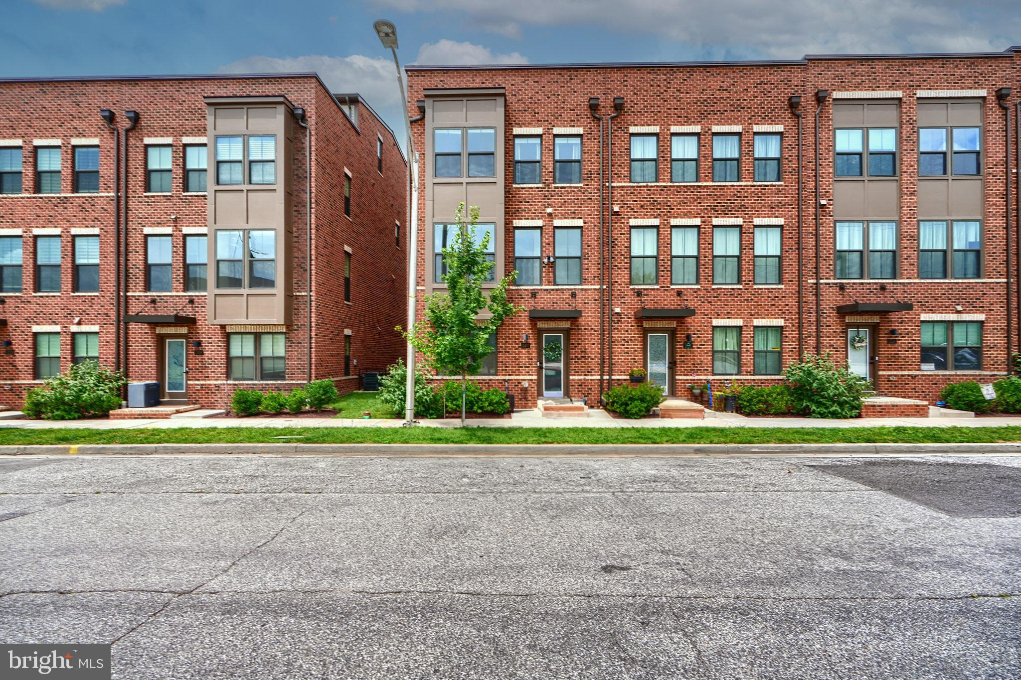 Welcome to 1522 Decatur located in the heart of desirable Locust Point. This spacious and modern end-of-group townhome offers four finished levels, 4 bedrooms, 4.5 bathrooms, two-car garage, and multiple outdoor living spaces — with a rear deck and rooftop terrace. Built in 2022, everything in this home is like new, featuring a neutral color palette, luxury vinyl plank (LVP) flooring throughout, dual-zone HVAC, and tankless water heater. The entry level starts with a large bedroom with private bath, coat and utility closets, and access to the rear two-car garage. The main level showcases an open-concept design with well defined living and dining spaces, half bath and high end kitchen. With two-tone cabinetry, crown molding, brushed nickel accents stainless steel appliances, butlers pantry, quartz countertops, bonus coffee bar and an oversized island with seating for four, this kitchen has it all. The third level includes three bedrooms, two to the front that share a full hall bath, and a rear primary suite with walk-in closet, large bath with double vanity, soaker tub, and glass-enclosed shower. The top level offers a spacious second family room, full bath, additional storage, and access to the rooftop, the perfect area for relaxing or entertaining. Move-in ready and the ideal location to the local shops, parks, bars and restaurants, this is city living at its best. Set up a showing today!