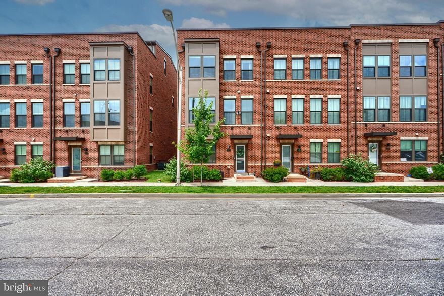 Welcome to 1522 Decatur located in the heart of desirable Locust Point. This spacious and modern end-of-group townhome offers four finished levels, 4 bedrooms, 4.5 bathrooms, two-car garage, and multiple outdoor living spaces — with a rear deck and rooftop terrace. Built in 2022, everything in this home is like new, featuring a neutral color palette, luxury vinyl plank (LVP) flooring throughout, dual-zone HVAC, and tankless water heater. The entry level starts with a large bedroom with private bath, coat and utility closets, and access to the rear two-car garage. The main level showcases an open-concept design with well defined living and dining spaces, half bath and high end kitchen. With two-tone cabinetry, crown molding, brushed nickel accents stainless steel appliances, butlers pantry, quartz countertops, bonus coffee bar and an oversized island with seating for four, this kitchen has it all. The third level includes three bedrooms, two to the front that share a full hall bath, and a rear primary suite with walk-in closet, large  bath with double vanity, soaker tub, and glass-enclosed shower. The top level offers a spacious second family room, full bath, additional storage, and access to the rooftop, the perfect area for relaxing or entertaining. Move-in ready and the ideal location to the local shops, parks, bars and restaurants, this is city living at its best. Set up a showing today!