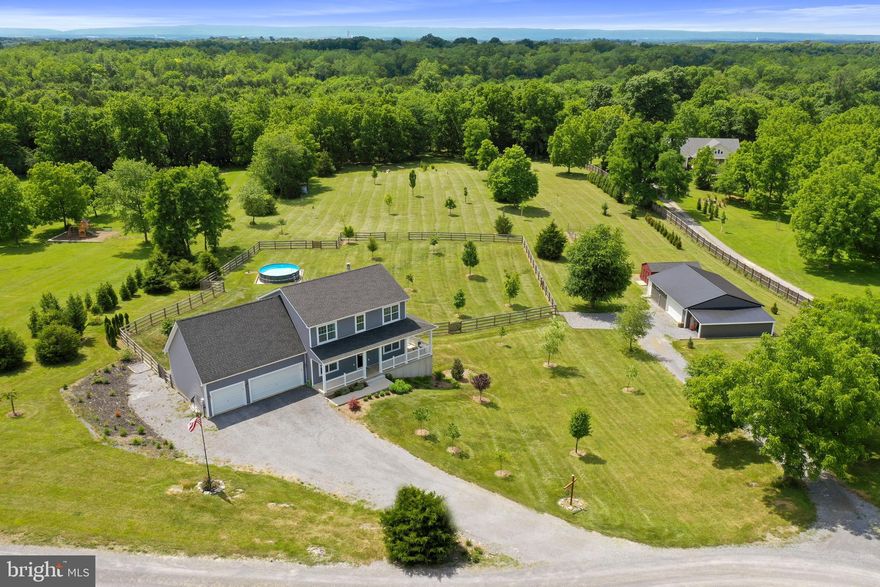 Beautiful homestead on just over 4 1/4 acres on outskirts of Shepherdstown. Built in 2017, this striking Colonial style home features 5 bedrooms, 3 1/2 baths, bonus room, formal living and dining rooms, gourmet kitchen and more! Luxury vinyl plank flooring predominantly throughout the home, 9' ceilings on the main level, large deck with stairs to fenced back yard, 18' dia above ground pool, 6+ person hot tub, wrap around covered front porch, 3 car attached garage.   The lower level is ready to finish into additional rooms or recreation area.  One of the bedrooms and full baths are on this walk out level. There is also a recently constructed 32' x 40' metal pole building with separated workshop/office area that has heat/AC via mini split and 2 car garage/shop plus - all under metal roof, with insulation, electricity, and heat. 30' x 11' run-in is attached.  3 miles to Shepherdstown, 1 1/2 hours to D.C..