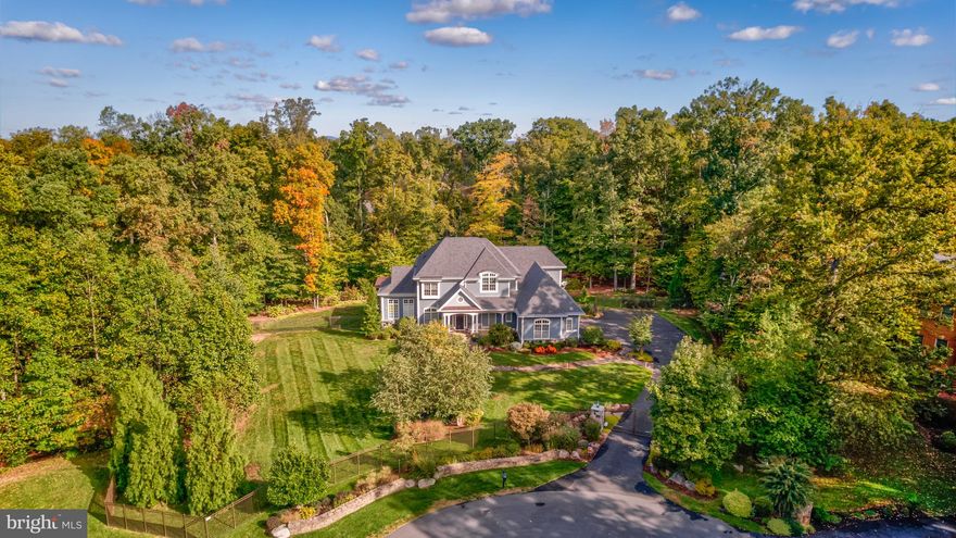 Open Sun 4/6 2-4pm, Tucked away at the end of a quiet cul-de-sac, this gated custom-built home spans over 7,000 square feet on nearly three acres, offering a rare balance of space, design, and functionality. From the flagstone walkway to the welcoming front porch, every detail has been carefully planned to create a home that is both inviting and impressive.
Inside, natural light pours through oversized windows, accentuating the soaring ceilings and thoughtful layout. The main level is designed for everyday living and entertaining whether it’s hosting in the dining room or unwinding in the family room which brings the outdoors in with its floor to ceiling sliding glass NanaWall which opens to a sweeping deck with a louvred ceiling and covered outdoor kitchen with built-in grill and pizza oven extending the outdoor experience year-round. 
The kitchen is the heart of the home featuring a generous island, custom cabinetry, exotic granite, and professional-grade appliances. A butler’s pantry with glass-front cabinetry and a beverage cooler keeps everything organized. Just beyond the kitchen is a sunroom offering a quiet space to recharge.   A well-equipped family foyer provides a mudroom including a professional dog-washing station and a bonus room which serves as the perfect hub for hobbies, organization, or homework

Upstairs, the primary suite is a true retreat, complete with a sitting area, a two-way fireplace, and two walk-in closets. The spa-like bath features a soaking tub, a seamless glass shower, and tranquil woodland views. 
The walkout lower level is designed for both relaxation and entertainment, featuring a great room with third fireplace, home theatre,  kitchenette and spacious fifth bedroom with a full bath and walk-in closet ensures privacy for guests. French doors open to a flagstone patio with a fire pit, oversized plunge pool and heated spa—creating a peaceful outdoor escape.
Located in the Langley High School pyramid, this home offers exceptional privacy without sacrificing convenience, all within one of Great Falls’ most sought-after communities.