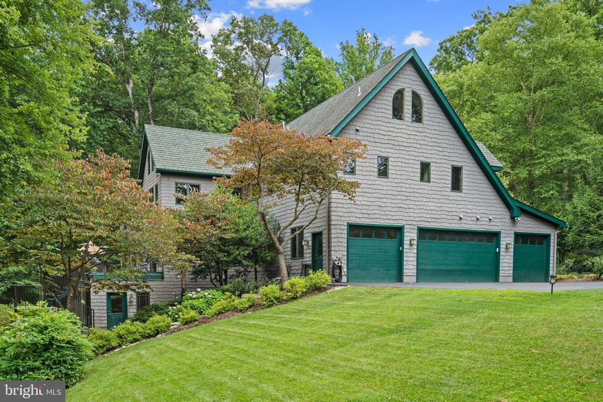 Welcome to 990 Millwood Ln! Timeless design and spacious yet intimate, this home is crafted for gathering—be it friends, overnight guests, or cherished memories. Nestled in mature wilderness yet conveniently close to shopping, the Metro, and DC, it offers the perfect blend of seclusion and accessibility. 

The heart of this home resides in its kitchen, beautifully balanced and refined with pecan wood accents and an octagonal island complete with hanging seats for storytelling and evening sharing. Functionally designed with dual sinks, two dishwashers, a wine fridge, and abundant cabinetry, it conceals the expansive nature of this residence. Whether hosting guests in multiple gathering areas or enjoying quiet moments with a book, 990 Millwood Lane effortlessly multitasks.
Step into the great room, where a fireplace beckons amidst vaulted truss beams, embodying the romantic construction and attention to detail rarely found in today's homes. Framed with native Eastern White Pine using traditional techniques, this house exudes character, charm, and enduring strength. After dinner, retreat to the veranda and extend your evening overlooking dense foliage and the soothing sounds of nature on Captain Hickory Run, your own slice of tranquility.
Nearly 4.5 acres of rolling terrain dotted with mature trees and meticulously landscaped gardens await exploration. Wander hardscaped pathways or forge your own, discovering the elegant nature that surrounds your slice of Earth.
Relaxation beckons by the Gunite pool, flanked by manicured gardens on one side and serene vistas on the other. Spend late nights by the firepit or enjoy a quick snack in the shade of the gazebo. Treasured out-of-town guests will appreciate moments spent on the front porch. An oversized 4-car garage accommodates car collections, special projects, and overflow storage needs.
The expansive lower level boasts a second kitchen and a dramatic fireplace within a 1,400 sq ft rec room adorned with 10-foot ceilings and full-sized windows—a stunning additional living space. Two hobby rooms—a studio and workshop—along with an alcove ideal for an office ensure ample room for pursuits. Overnight guests will feel at home in their private suite with an attached full bathroom. The built-in pet washing station and second laundry station cater to both furry friends and human guests, who can utilize the convenient half bath during gatherings like March Madness. Additional storage options include a butler’s pantry and under-stairs storage for seasonal items.
Sleeping accommodations abound in four spacious rooms, each graced with large south-facing windows, vaulted ceilings, and expansive loft areas. Walk-in closets with organizers and access to two large hall baths enhance each bedroom’s appeal. Upper-level laundry space with room for storage. An additional room overlooking the great room serves as a gym, office, study nook, or additional bedroom.
The private primary bedroom overlooks peaceful woods and features a sitting room, dual walk-in closets, and an ensuite bathroom. The private rooftop balcony with a hot tub is the perfect retreat after a long day. 
Finally, the home’s intelligence shines through in its thoughtful features: a 60-year roof, radiant floor heating supplemented by forced air, multi-zoned heating and air conditioning for optimal comfort, 300-amp electrical service, comprehensive hardwiring throughout, and top-tier insulation for ultimate comfort. A 16-zone garden sprinkler system ensures grounds stay lush, while the pool boasts programmable water features and a jetted tub, all infrastructure discreetly tucked away.