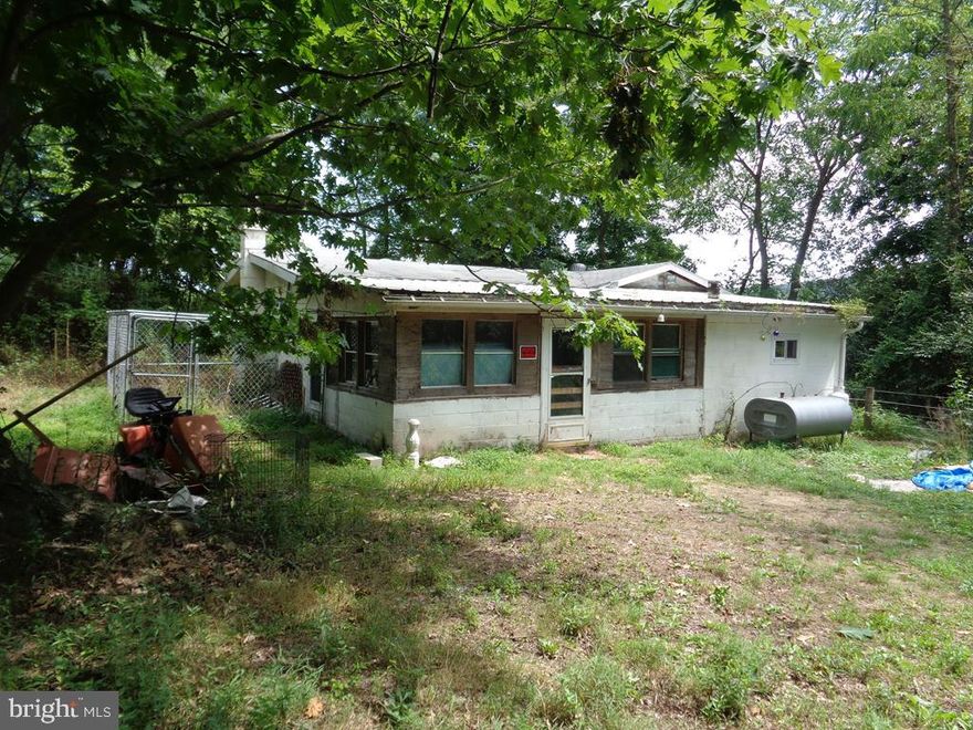 1.3 Acre parcel at edge of Stone Hollow Farm (upscale horse ranch) all by itself.  Setting is rare, hard-to-find standalone parcel.  House was original log cabin, added onto several times.  Septic was serviced.  Well did work, needs pressure switch maybe other.  Buyer will sign AS-IS CLAUSE.  Recent electric service, heating fuel tank, woodstove.