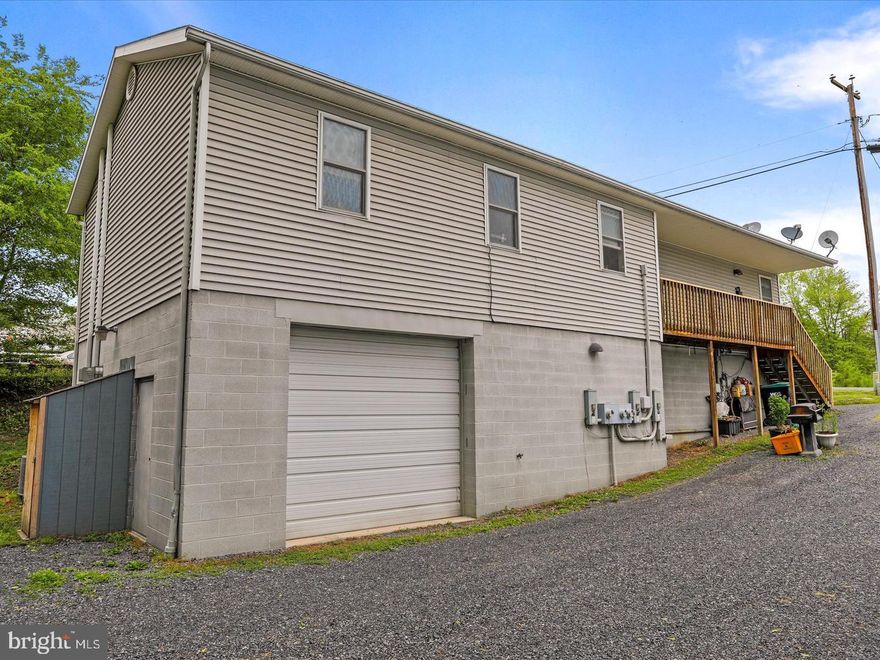 Attached oversized one-car garage with oil furnace heating and a 10-foot door. This property is zoned commercial, offering the option to run a business out of the garage if desired.  Can be used for light mechanic shop, storage or any commercial business.