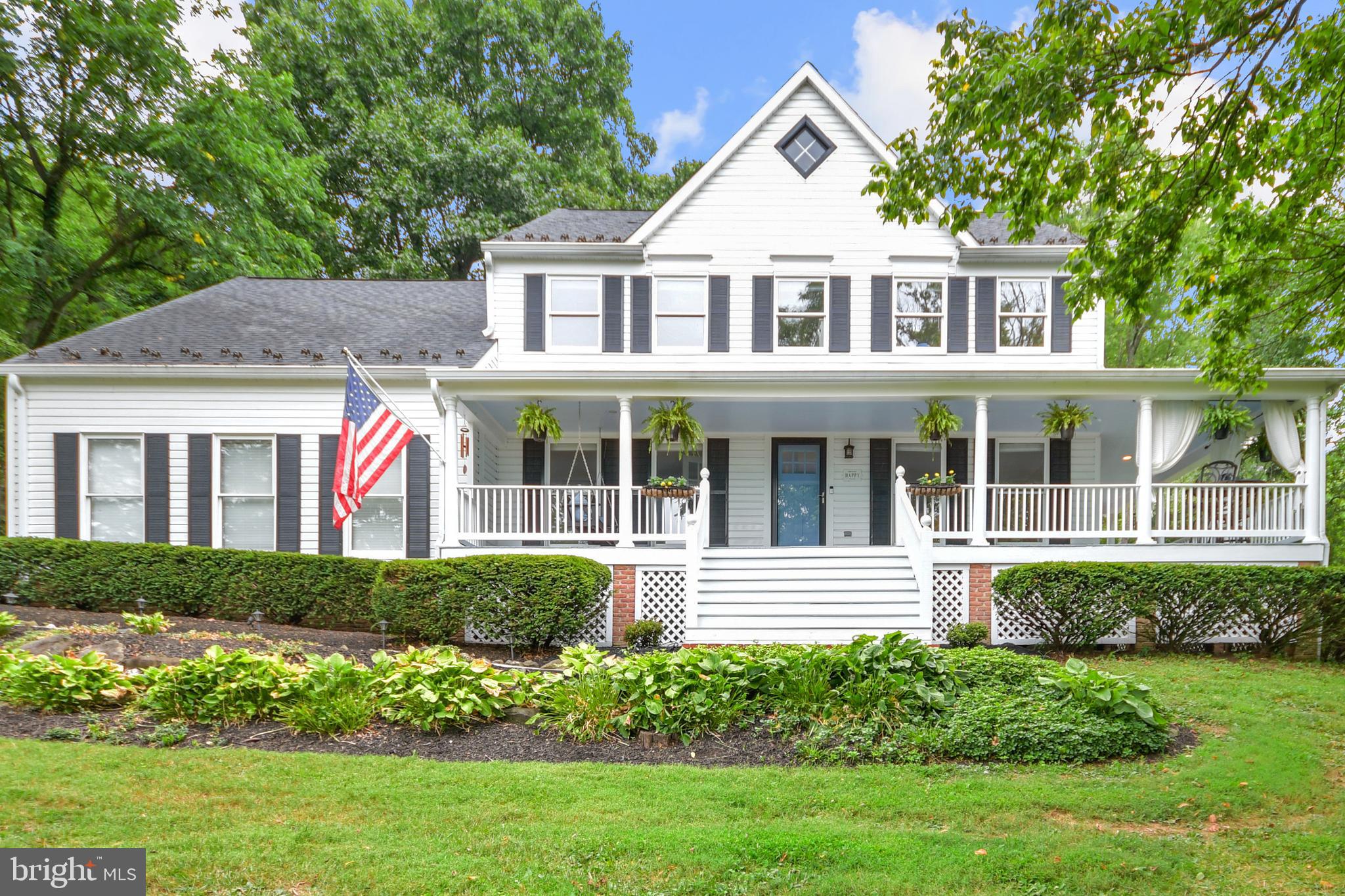 Sophisticated Style. Southern Charm.
Welcome to 6735 Deer Spring Lane, nestled in the Middletown Valley. Here you’ll be greeted by wide, welcoming stairs leading you to a deep, wraparound porch garnering instant appeal. Every corner of this home invites you to linger and take in all it has to offer. Each window showcases the natural habitat outdoors in what feels like your private oasis on 1.78 acres of land. Step inside to hardwood floors leading you towards the kitchen and family room. Find neutral painted walls and fresh carpet in the formal living and dining rooms which are to the right of the front entrance. To the left of the front entry, French doors open to a room beaming with built-in shelves and storage, complete with hardwood flooring. Make this space your professional office, personal library, or creative nook. The kitchen offers a custom island topped with quartz, stainless steel appliances, granite countertops, and a pass-through window overlooking the spacious, four-season solarium. This is where you'll start and end your days during any season viewing nature’s best from all angles. The open family room offers hardwood floors, cathedral ceiling, skylights, a painted brick fireplace and hearth, French doors opening to the rear deck, and a spiral staircase to a loft area suitable for a second office or cozy gathering space. The Primary bedroom is freshly painted and carpeted, with a barn door opening to the primary full bathroom and dressing area. Three additional bedrooms possess fresh carpet, neutral paint, and a few extra touches like chair rails and wainscotting. The second full bathroom offers a dual sink vanity, tub and shower combo, ceramic tile, and laundry chute. The basement level is finished to include a large laundry center complete with shelving and ceramic tile, a third full bathroom, two additional carpeted rooms, and a recreational area which can double as an in-law suite or fifth bedroom, connecting to a second full kitchen with walkout egress. From the welcoming, wraparound porch to the immense, freshly painted deck, a four-season solarium, large family room, formal dining room, and finished basement complete with a second kitchen…this home checks off every entertainer’s wish list. The two-car garage offers extra storage options and a unique walk-through garage door for easy access to six additional parking spaces on the property. A shed in the back yard provides storage for lawn equipment. Two separate electric fences allow roaming space for animals. Enjoy serene and tranquil privacy as you select your favorite happy spot in this well-maintained home with over 4,000 total square feet. Perfectly positioned in a sought-after school district. Close to commuter routes and shopping. Come see for yourself, the only thing missing at 6735 Deer Spring Lane in Middletown, MD….is you!