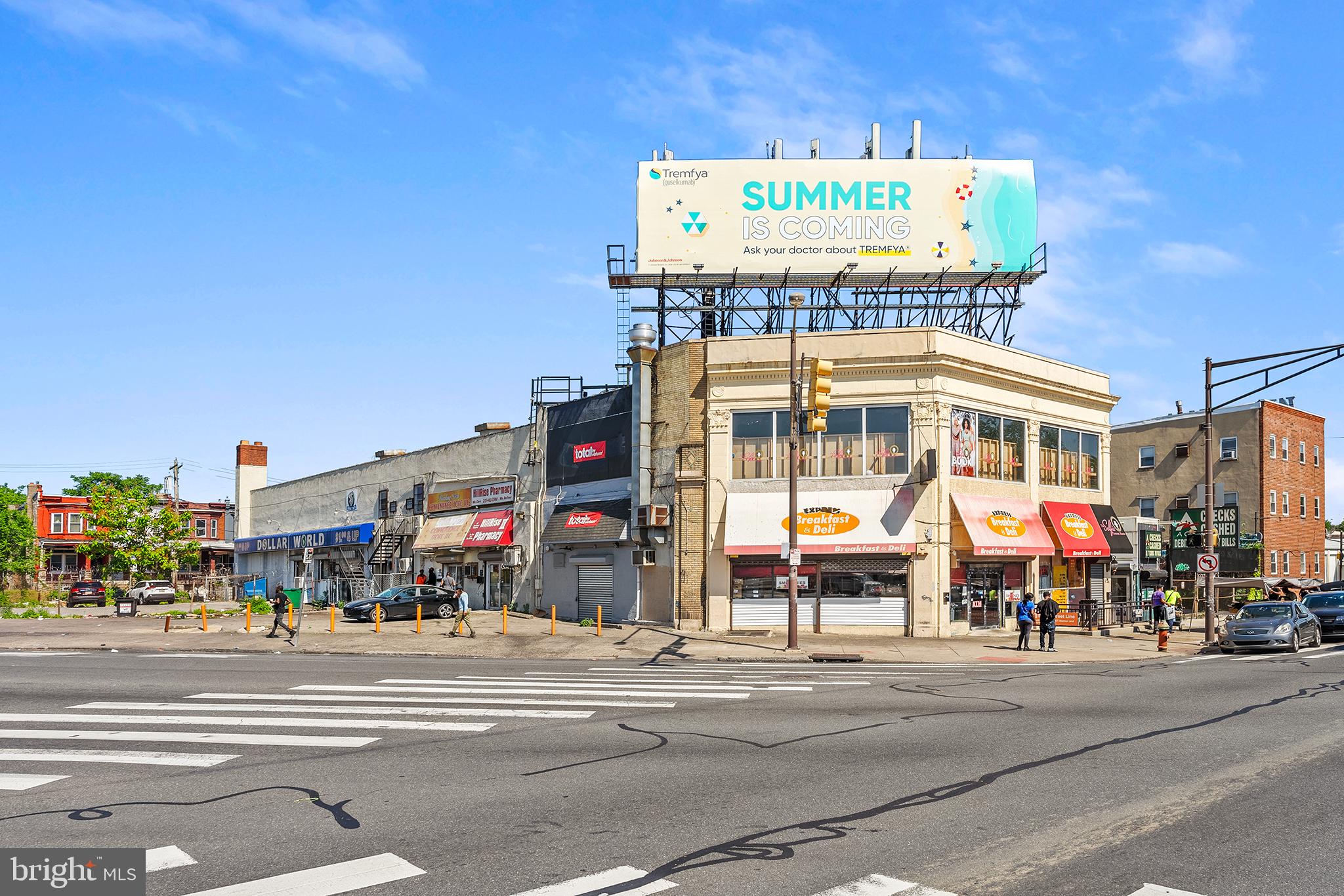 Located at the bustling intersection of N Broad Street and W Roosevelt Blvd, this fully rented commercial building offers a lucrative investment opportunity in a high-traffic area. The property boasts a diverse mix of tenants and a range of income-generating features, making it an attractive option for savvy investors.
The building is currently occupied by a variety of tenants, ensuring a steady income stream. Tenants include a Dollar Store, Pharmacy, Convenience Store, Deli, and a Selfie Room. Additional revenue includes a rooftop billboard equipped with Verizon antennas. The property also features rollup garage doors on the side, providing convenient loading and unloading. A ramp leads to the second floor, which is exclusively occupied by the selfie room.
This commercial property is an exceptional investment opportunity, offering stable rental income, additional advertising revenue, and a prime location. Don’t miss your chance to own a valuable piece of real estate in a thriving commercial district.