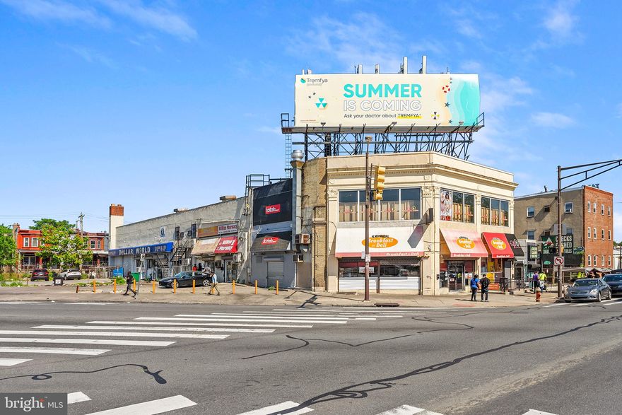 Located at the bustling intersection of N Broad Street and W Roosevelt Blvd, this fully rented commercial building offers a lucrative investment opportunity in a high-traffic area. The property boasts a diverse mix of tenants and a range of income-generating features, making it an attractive option for savvy investors.
The building is currently occupied by a variety of tenants, ensuring a steady income stream. Tenants include a Dollar Store, Pharmacy, Convenience Store, Deli, and a Selfie Room. Additional revenue includes a rooftop billboard equipped with Verizon antennas. The property also features rollup garage doors on the side, providing convenient loading and unloading. A ramp leads to the second floor, which is exclusively occupied by the selfie room.
This commercial property is an exceptional investment opportunity, offering stable rental income, additional advertising revenue, and a prime location. Don’t miss your chance to own a valuable piece of real estate in a thriving commercial district.