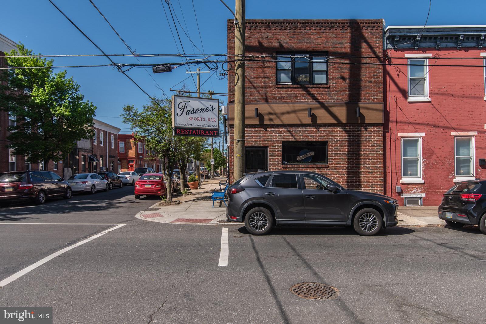 For Sale: Turnkey Bar & Restaurant in the Heart of Port Richmond – 2656 E Ann Street. Located on a prime corner lot, this brick-front commercial gem offers an unbeatable combination of location, functionality, and charm. Step inside to a fully equipped bar and restaurant space, featuring rustic-modern finishes, rich wood accents, and seating that accommodates both intimate gatherings and lively crowds. The bar boasts multiple flat-screen TVs, ceiling fans throughout, high-top seating, and plenty of space for darts, pool, or live music. A fully functional kitchen is ready for operations, complete with commercial-grade appliances, prep areas, and storage. Upstairs, discover a spacious private banquet room with its own bar, ideal for private parties, events, or a potential income-producing rental opportunity. Updated restrooms on both floors add convenience for patrons and staff alike. Additional highlights: Corner visibility with strong foot and vehicle traffic, liquor license included, well-maintained and clean interior, and steps from I-95 and minutes from Fishtown, Bridesburg, and Northern Liberties. Whether you're an investor looking for a cash-flowing business or an entrepreneur ready to make your mark, 2656 E Ann Street is your opportunity to own and operate in one of Philly’s most vibrant neighborhoods. Schedule your tour today and bring your vision to life in this iconic Port Richmond spot.
