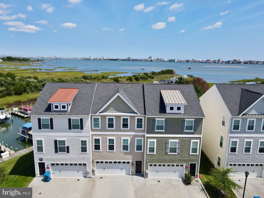 Stunning Bayfront End Unit with Deeded Slip in Seaside Village!
Welcome to 12905 Sand Bar Ln #3, an extraordinary bayfront end unit in the highly desirable Seaside Village community of West Ocean City. This impeccably maintained home boasts panoramic views of Ocean City and the Bay, along with deeded slip #23 with a lift just steps from your back door.
This spacious villa offers three levels of superior living space, featuring a unique 11'x11' bump-out on each level, enhancing the living and entertaining areas. The home is one of only three units equipped with hurricane impact-rated windows and sliding doors, providing added security and peace of mind.
Inside, the open floor plan is perfect for entertaining, highlighted by gorgeous hardwood floors, 9-foot ceilings, and custom millwork throughout. The gourmet kitchen is a chef's dream, with 42" custom cabinetry, granite countertops, a glass tile backsplash, and stainless-steel appliances. Adjacent to the kitchen, the dining area and lounge space offer stunning water views and access to a covered balcony.
Upstairs, the primary suite is a serene retreat with a walk-in closet, spa-like ensuite, and a private sitting area leading to a balcony with breathtaking views. Two additional bedrooms, a spacious hall bath, and a full-sized laundry center complete the upper level.
The lower level features a family room, custom bar area, full bath, and interior access to the garage. Step outside to the covered rear patio, just a short walk to your deeded boat slip.
Ideally located, this home is within walking distance to outlet shopping, dining, entertainment, world-class golf, and fishing, with easy access to the Ocean City Boardwalk and Assateague Island. If you're seeking stunning views and convenient water access, this is the perfect beach getaway or forever home. Don't miss the opportunity to make it yours today!