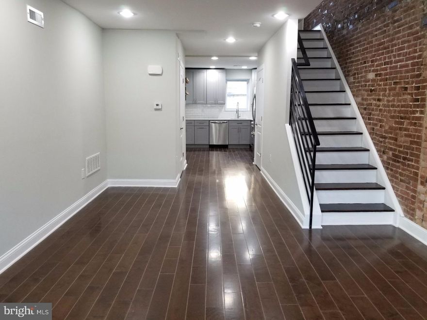 This beautiful house has been impeccably renovated with no detail spared. Located in E. Passyunk Crossing, one of the most desirable neighborhoods in all of Philadelphia, It is half a block from five of the top restaurants in Philly and steps from the famed Passyunk Avenue Fountain. You won't find another home on the market for this price and quality; it's the one you have been waiting for.  Enter the home from a quiet tree-lined street to an open floor plan with living room, dining area, powder room, and modern kitchen. The kitchen has grey 42" high end shaker style cabinets, beautiful quartz countertops, white marble mosaic backsplash, and stainless steel appliances. The finished basement adds to the beauty and spacious feel of this home, with laundry area located separately. The second floor offers two large, well-appointed bedrooms both with closet space. There is a spacious full bathroom with modern finishes, vanity and large tub. The master bedroom suite has a beautiful, private master bath with custom stand up shower. The house has brand new electrical, plumbing and HVAC systems, and hardwood floors throughout!  The ideal location is a short walk to all the great restaurants and everything that Passyunk Ave has to offer!! It's also only a few blocks from the Broad St subway. It is situated on a beautiful tree-lined block where there's no meters or limit for parking. You will feel at home the minute you walk in. 10 year tax abatement approved and 1 year builder's warranty included.