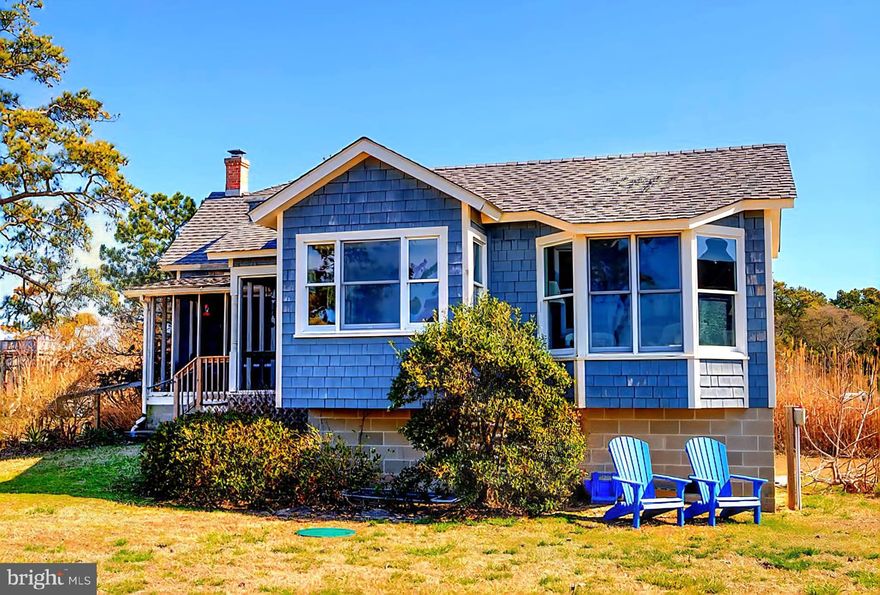 Waterfront Gem with Pier & Sunset Views! Discover the charm of island living w/ this adorable bayfront cottage, perfectly positioned on two parcels—one featuring the home and the other offering direct waterfront access with a private pier and dock complete with a built-in surround bench, ideal for soaking in breathtaking sunset views over the bay. Full of character & classic coastal charm with modern touches. Original hardwood plank flooring, a beautifully updated kitchen with granite countertops, both first and second-floor bedrooms & baths for flexible living. Wake up to serene bay views from the bedroom’s charming bay windows. Enjoy the outdoors from both front & rear screened porches-Great Coastal Breezes. Secluded & Peaceful setting. Large Shed. Pond in Back. Freshly Painted Home.