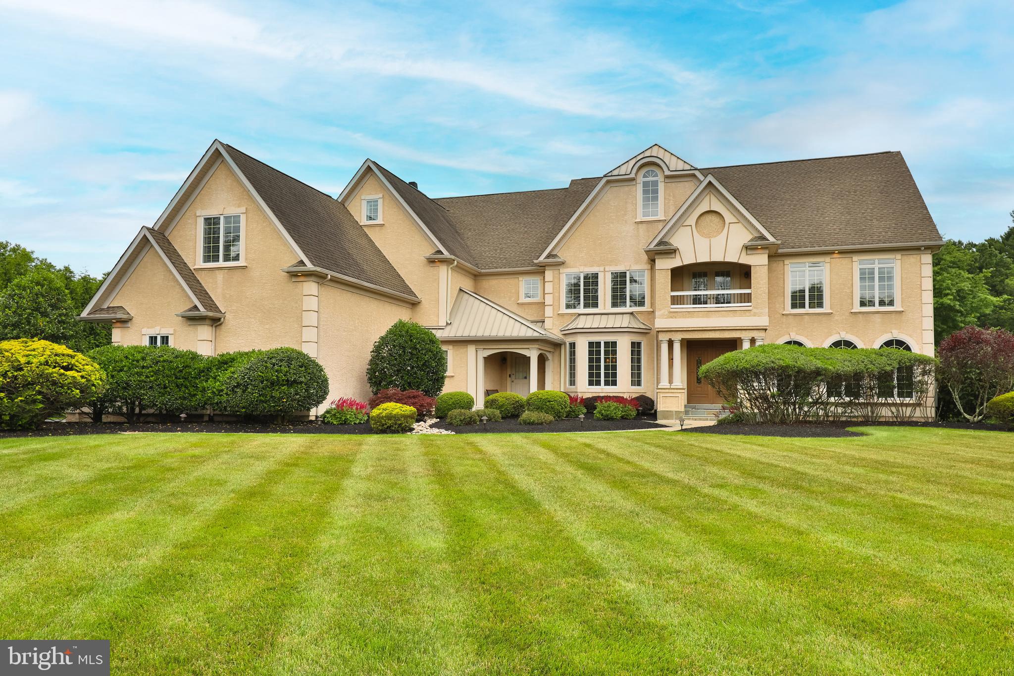 Don't miss this extraordinary estate home situated on over an acre of beautifully maintained grounds located the prestigious Greystone community. This custom built Gigliotti home boasts over 7,000 square feet of luxury living space including 5 bedrooms, 5 full baths and 2 half baths. The spectacular entrance foyer includes marble flooring with a dramatic open staircase and beautiful crown molding. The main level features a beautiful formal living room and dining room, a large office with built ins a spacious kitchen with granite counters, custom cabinets and French doors leading to the expansive deck there is also a a butler's pantry and large breakfast room with an attached screened in porch. The great room with cathedral ceilings is perfect for entertaining with a gas fireplace and large windows to view the private treelined lot and an open back staircase. Upstairs is the master suite including an open sitting area with a veranda overlooking a scenic pond with a fountain and a master bath with an oversized dual shower, his and her vanities, a jacuzzi tub, three walk-in closets and two linen closets. The second floor includes three additional bedrooms two additional baths and an additional en-suite with a sitting area for a total of five bedrooms. The lower level features a game room two additional bedrooms, an exercise room and large theater. All of the tray ceilings in this home are dramatic are each different from the other. There is also a laundry shoot, central vacuum and three zone heat and air.
