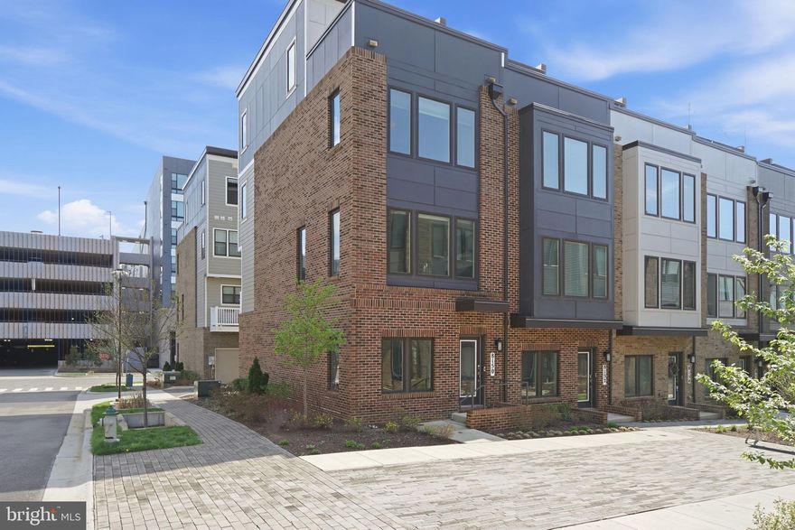 Welcome to 8150 Tompkins Street in the highly sought-after Westside at Shady Grove Metro community — a beautifully designed, nearly new townhome offering over 2,700 square feet of modern, light-filled living space in an unbeatable Rockville location.

Built in 2021, this multi-level residence blends contemporary design, generous scale, and everyday functionality, creating the perfect setting for both comfortable living and effortless entertaining. The main level features a bright, open-concept layout with huge windows , allowing natural light to pour through the home. The spacious family room flows seamlessly to a private rear Trex deck, ideal for outdoor dining, relaxing evenings, or hosting guests.

At the center of the home is a gourmet kitchen designed to impress — complete with an oversized quartz island with seating, sleek cabinetry, stainless steel appliances, and abundant prep and storage space. A pantry and main-level powder room add convenience and practicality.

Upstairs, the owner’s suite offers a peaceful retreat with a large walk-in closet and an en-suite bath featuring dual vanities and a frameless glass shower. Two additional well-proportioned bedrooms, 2 more full baths, and a conveniently located laundry area and large, sun filled rooftop terrace completes the upper levels.

The entry level provides direct access to the attached garage, additional storage, and flexible space to suit your needs.

Residents of Westside at Shady Grove enjoy resort-style amenities, including a community pool, clubhouse, playgrounds, dog parks, and scenic walking paths. The location is exceptional — just minutes to the Shady Grove Metro, with easy access to I-270, MD-200 (ICC), and nearby parks, public golf courses, shopping, and dining.

8150 Tompkins Street offers the perfect balance of modern living, community lifestyle, and commuter convenience — an outstanding opportunity in one of Rockville’s most desirable neighborhoods.

Twilight Open House Thursday 4/9 from 5-7pm!
Open House Saturday 4/11 from 2-4pm!