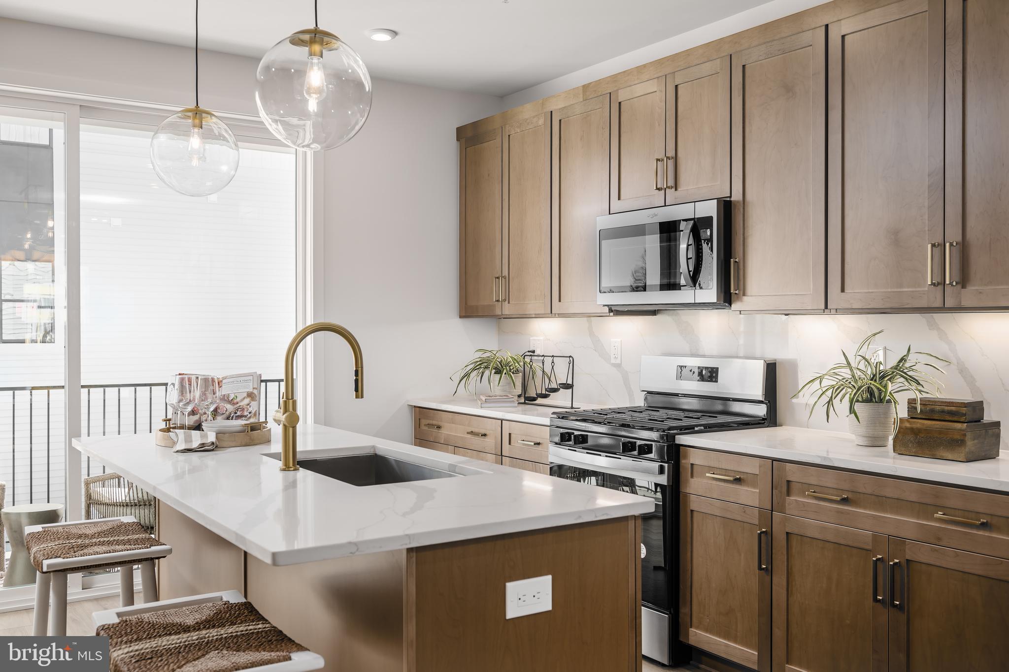 Experience the ideal combination of modern living and serene surroundings at Commonwealth Place, where comfort and style meet convenience. This exceptional Louis Woodbury corner unit offers the added benefit of extra greenspace and abundant natural light, making it the perfect retreat. Its thoughtfully designed layout and premium features set it apart, creating a sophisticated yet welcoming atmosphere that you'll love coming home to. The home features an inspired rear kitchen, designed for both style and function, with premium Whirlpool stainless steel appliances, sleek quartz countertops, and beautiful, modern cabinetry that adds a unique touch. The abundance of windows fills the space with natural light, creating an inviting atmosphere. Additional highlights include a rare two-car covered tandem garage, providing both convenience and ample storage, along with a private covered balcony for outdoor enjoyment. With thoughtful upgrades and modern selections throughout, this home is ready for you to move in and make it your own. Don't miss this incredible opportunity for a stunning quick move-in home—schedule an appointment today and get ready to settle into your new home by August/September 2025!